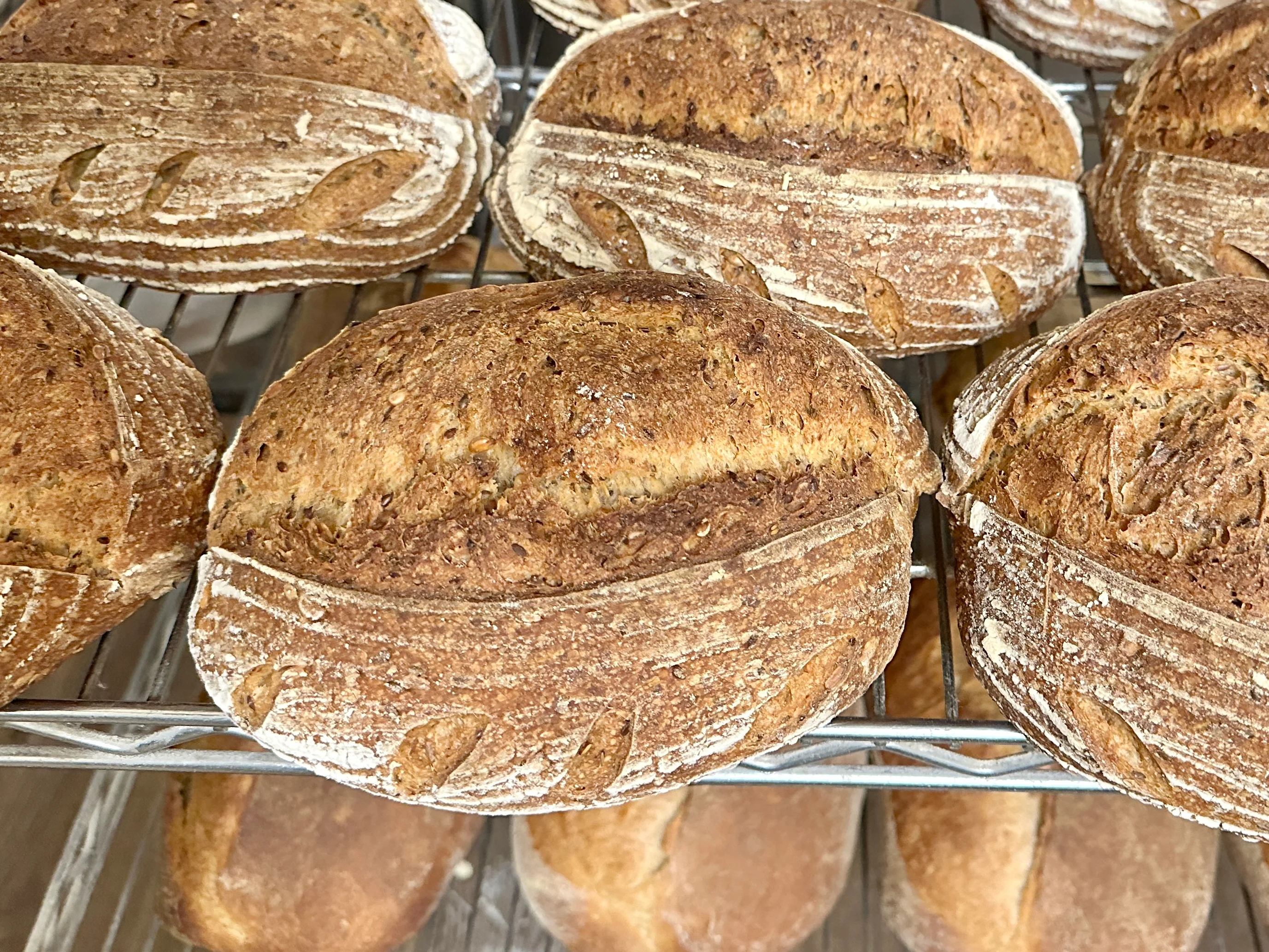 Artisan sourdough loaves cooling on a rack