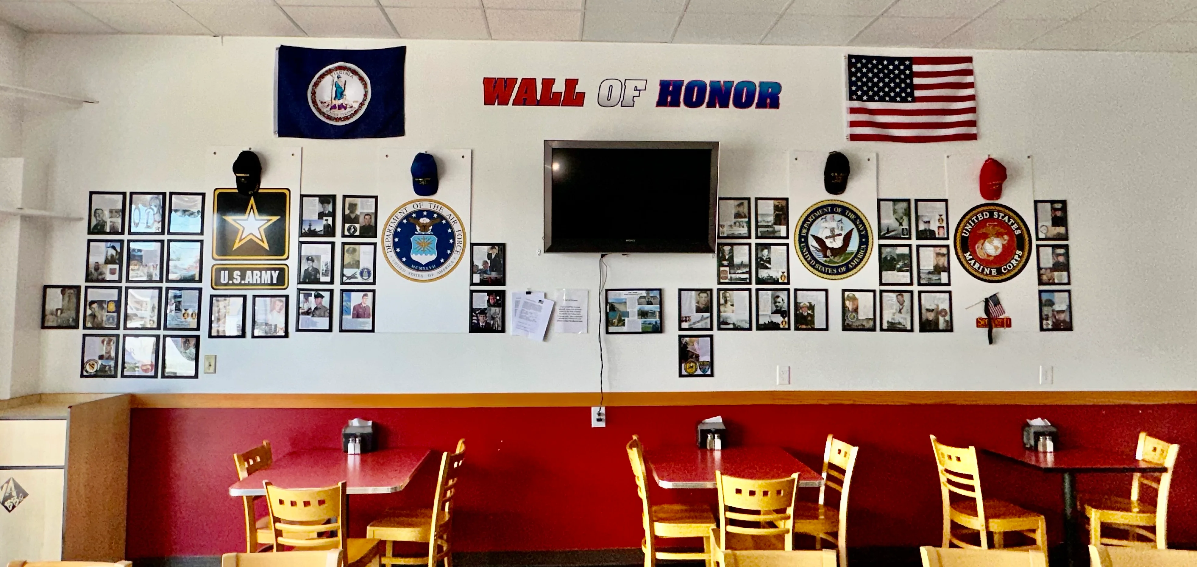 Cozy restaurant interior featuring a Wall of Honor