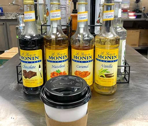 Variety of Monin flavored syrups for coffee drinks