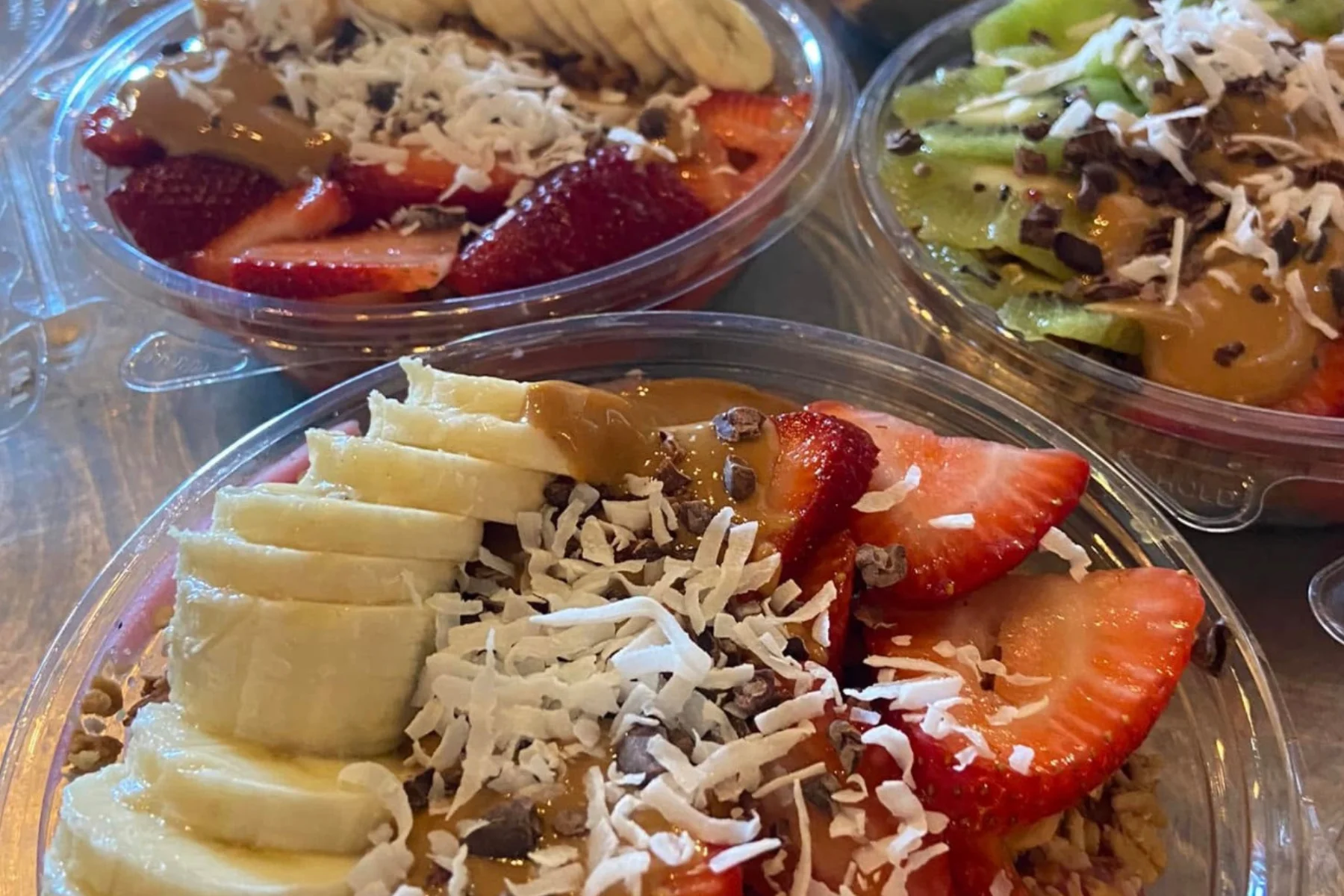Colorful acai bowls topped with fresh fruits