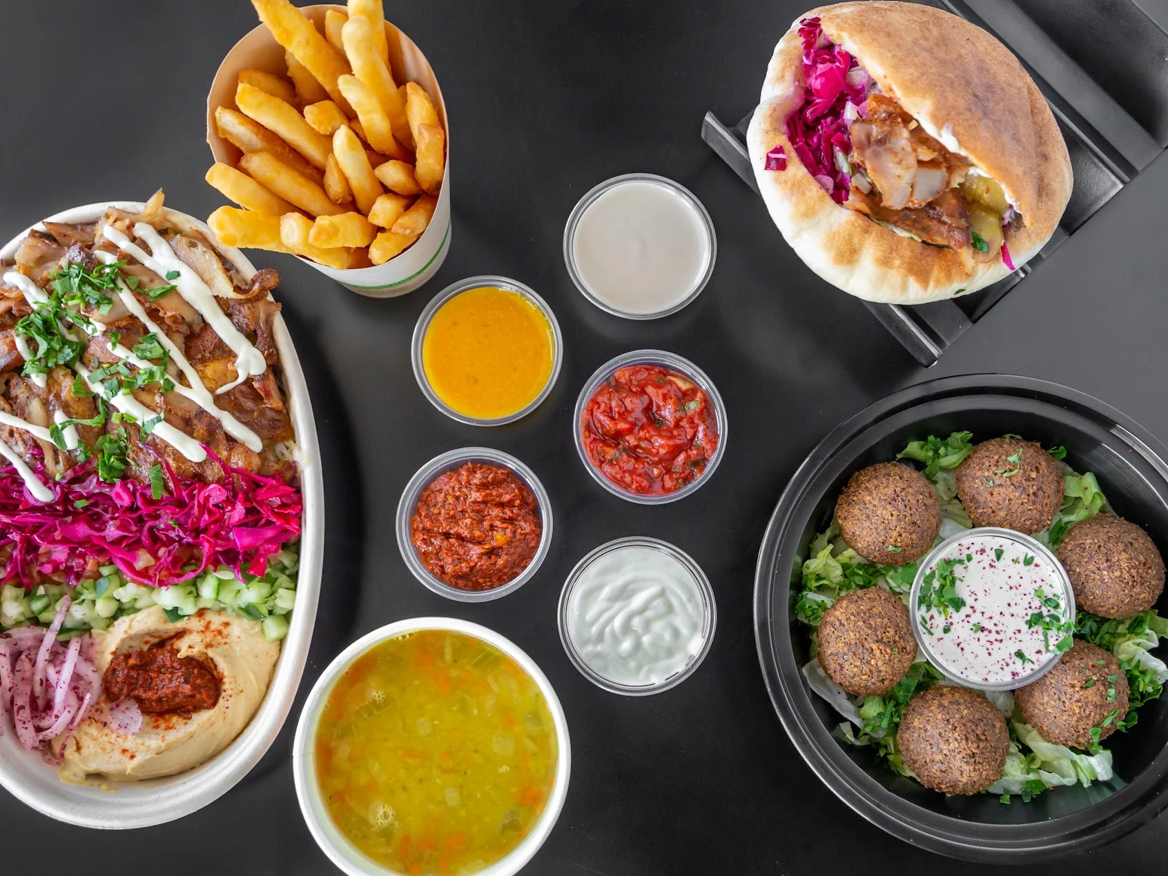 Mediterranean platter with shawarma, falafel, and sauces