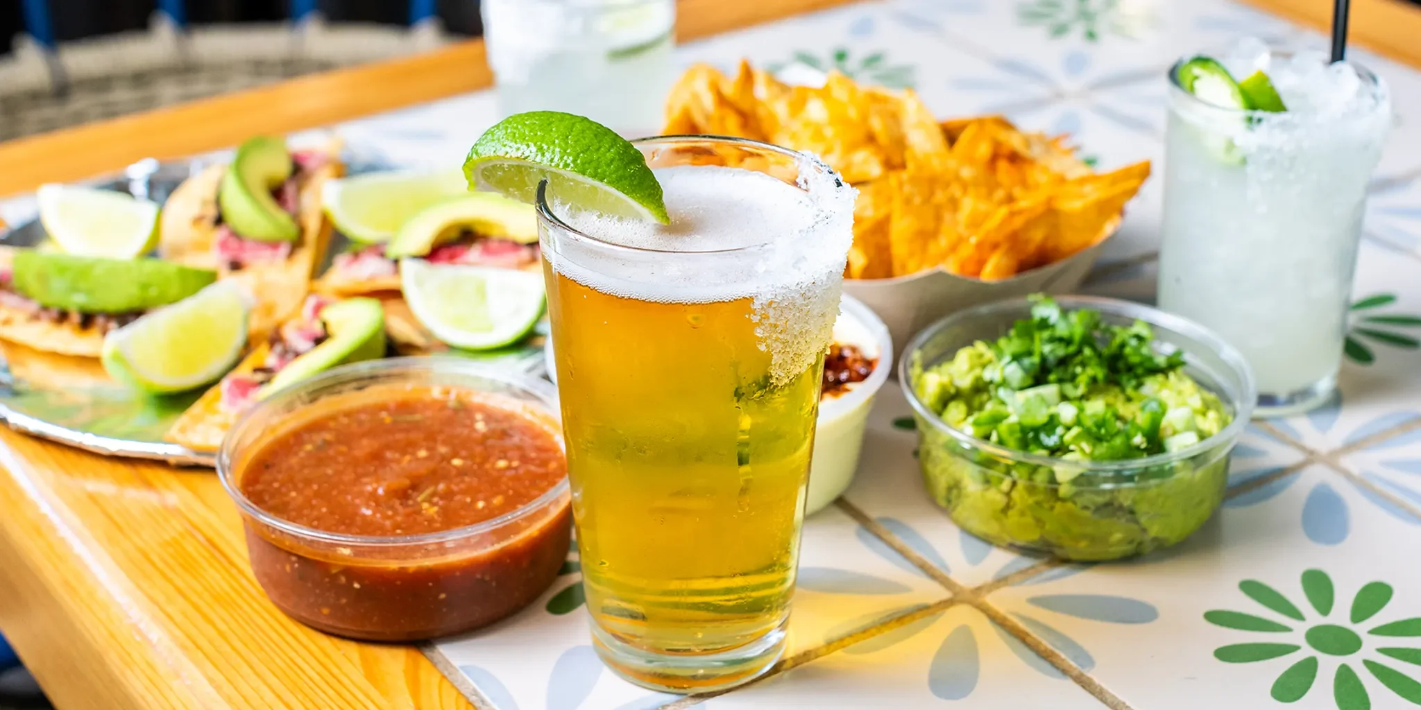 A restaurant chef preparing a dishGrilled chicken tacos and a craft beer for a Taco Tuesday happy hour.