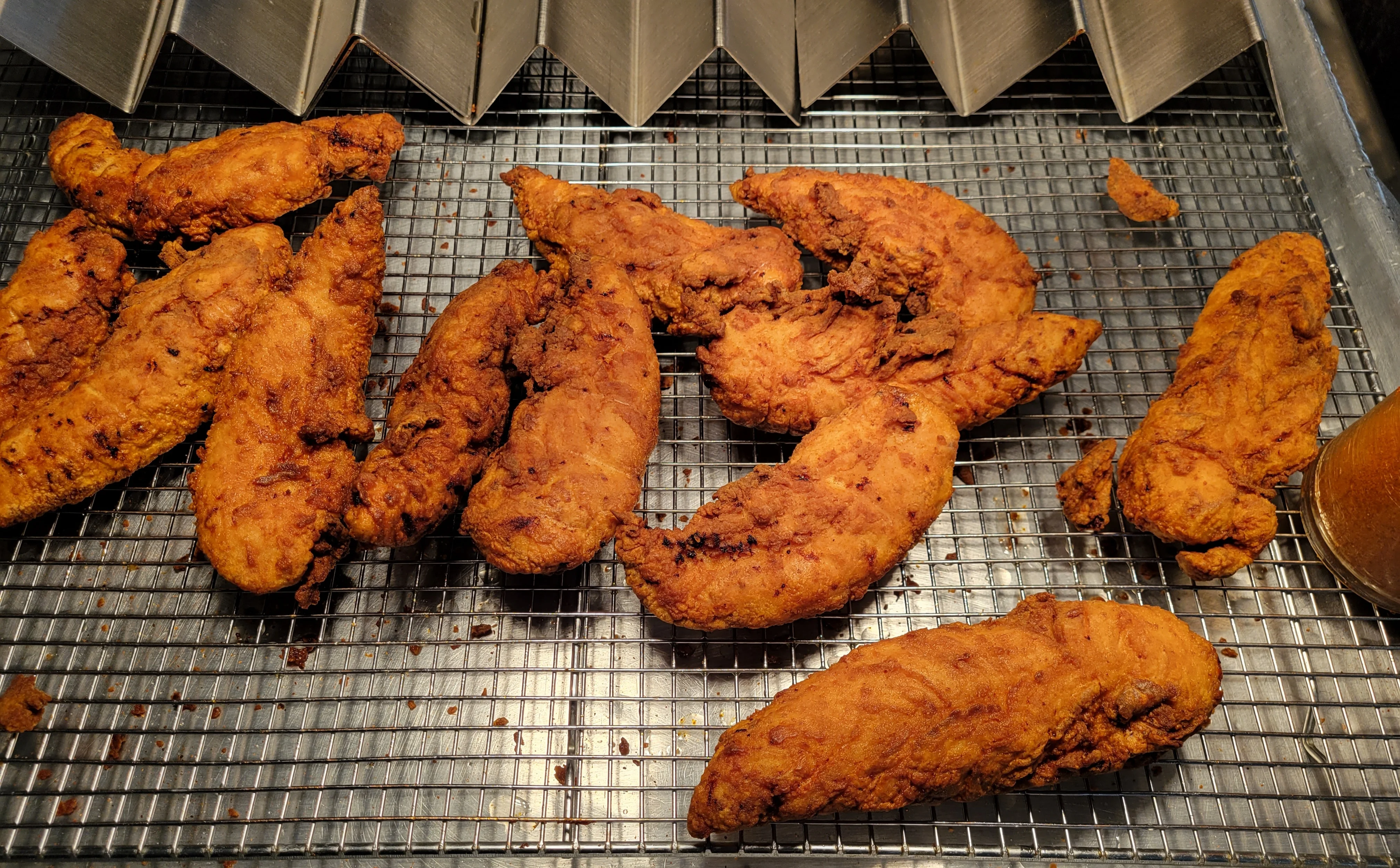 Crispy Southern fried chicken tenders on a cooling rack