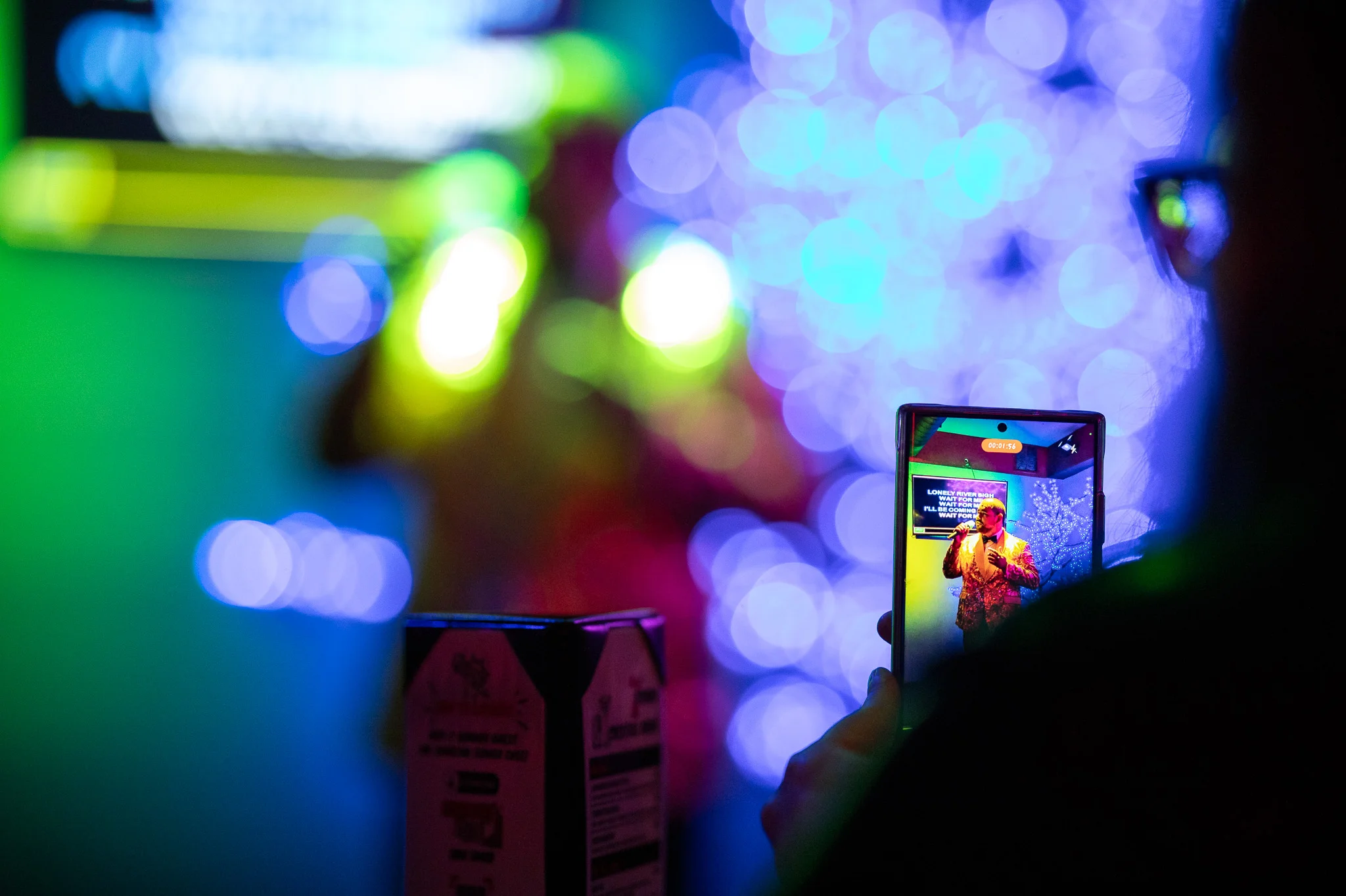 Live performance captured on smartphone at a vibrant venue