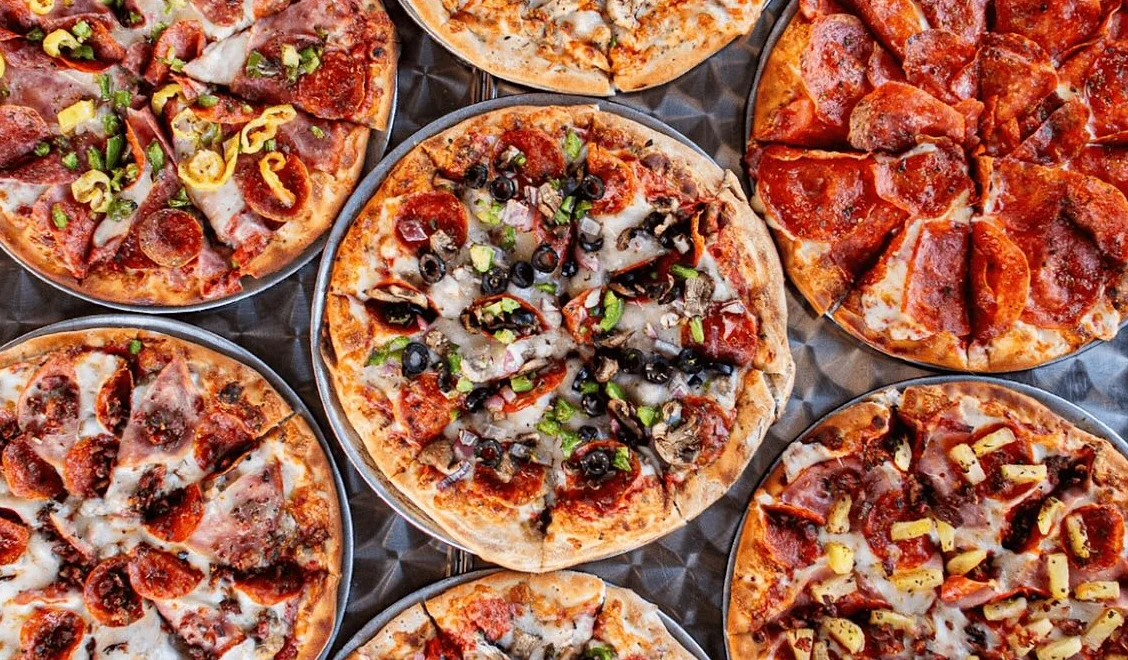 Variety of pizzas including pepperoni and Hawaiian styles