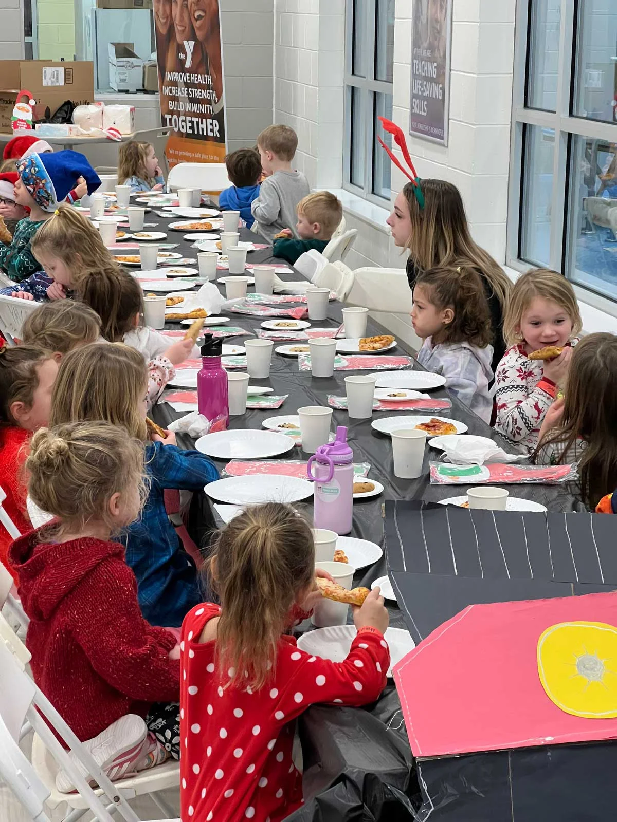Children enjoying pizza at a festive gathering