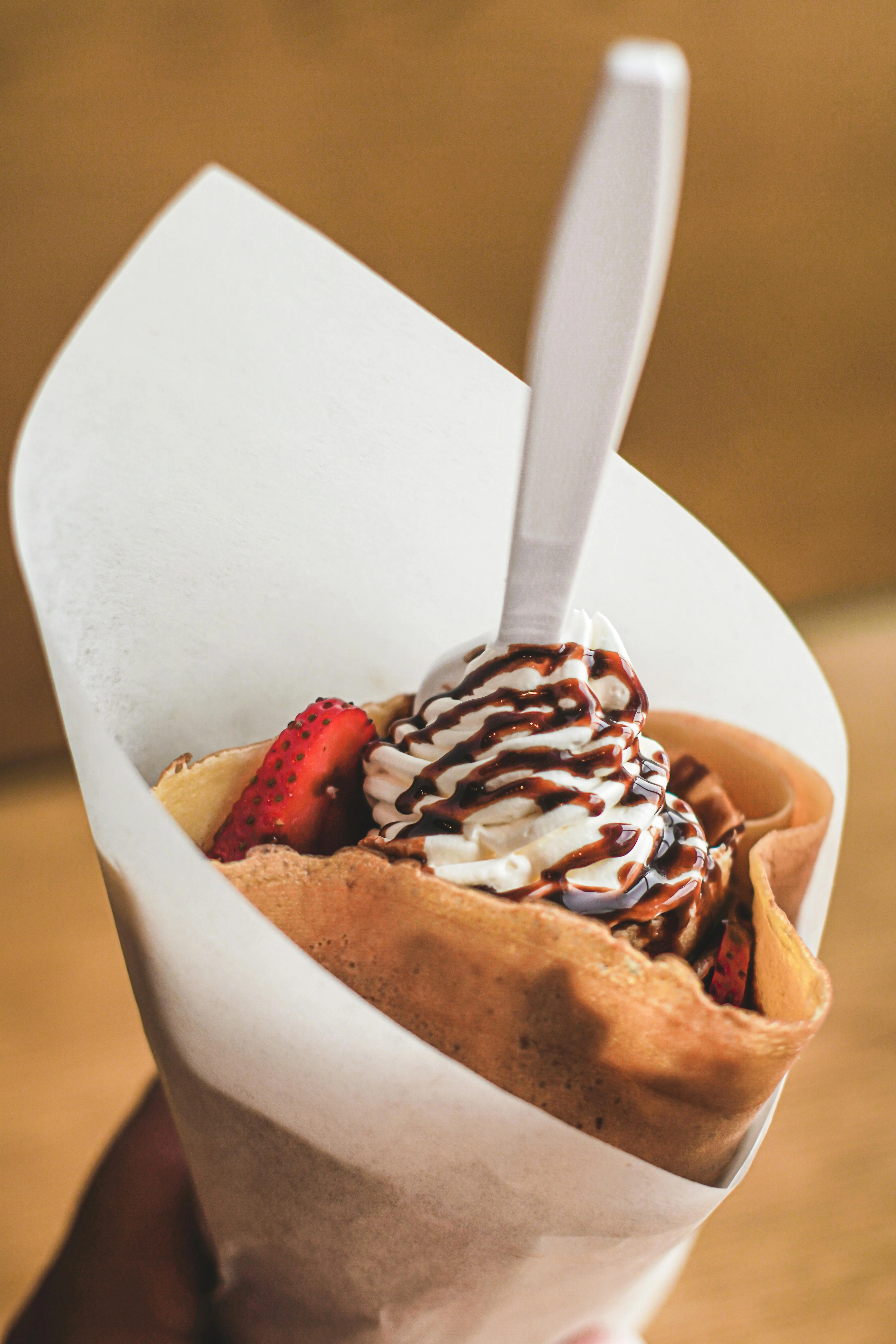 Delicious Japanese crepe filled with strawberries and whipped cream