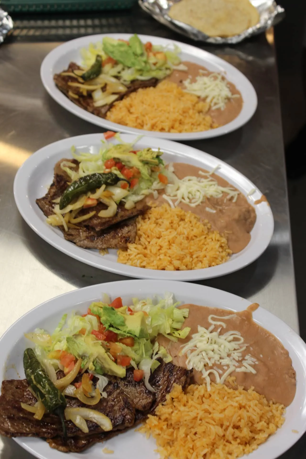 Plates of Mexican carne asada with rice and beans
