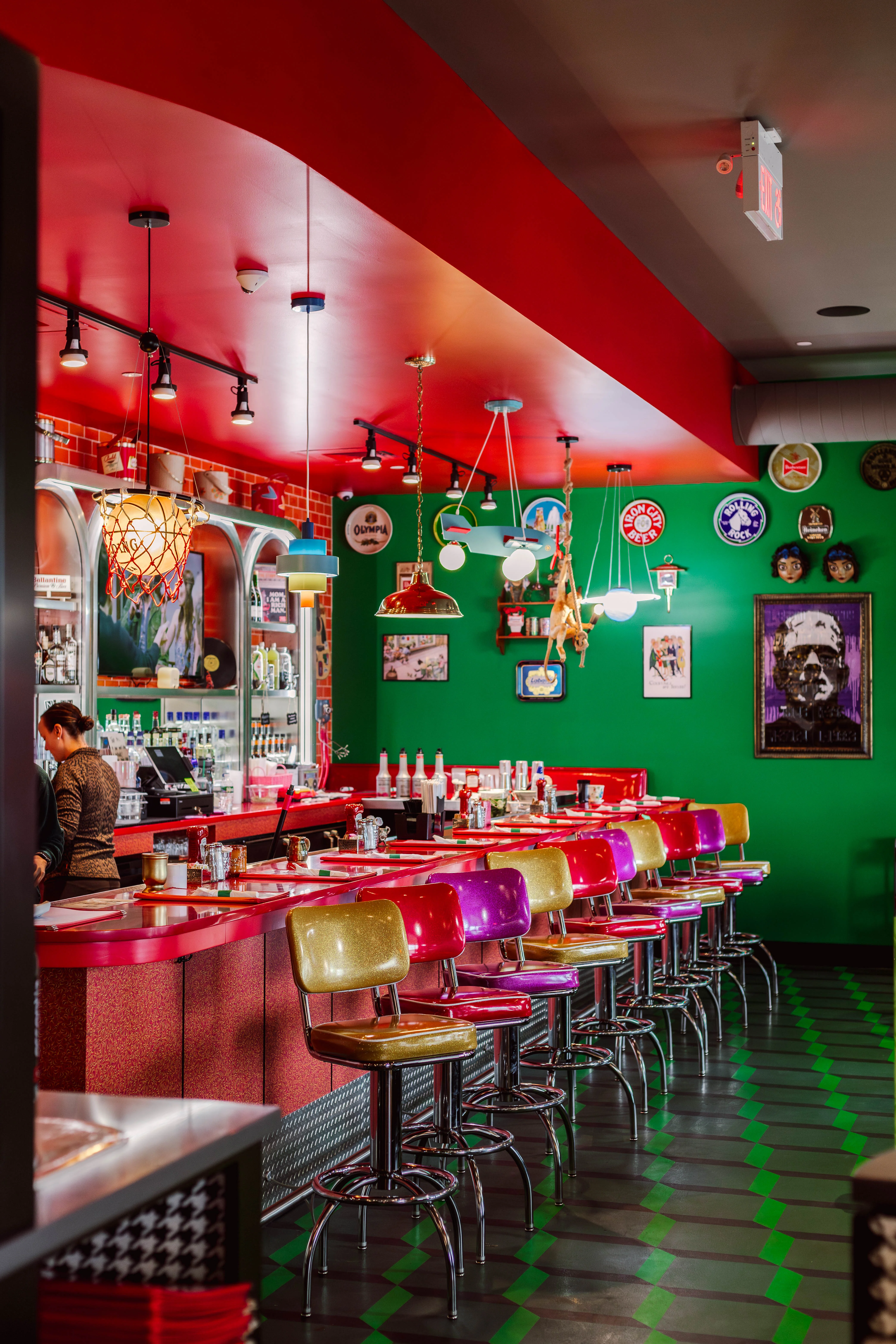 Vibrant restaurant interior with colorful bar stools and eclectic decor