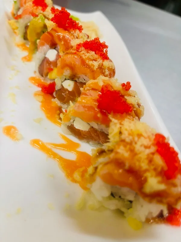 Colorful sushi roll with shrimp and spicy sauce