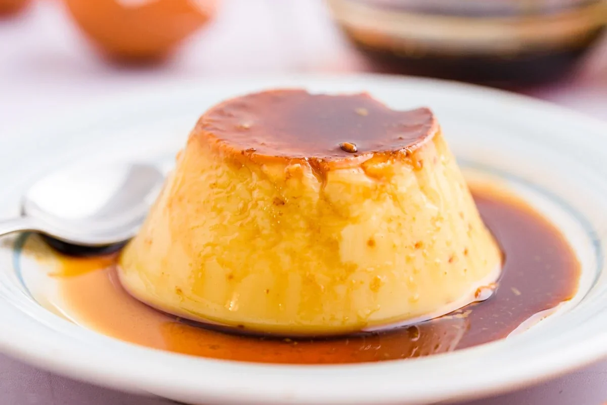 Classic flan dessert with caramel sauce on a white plate