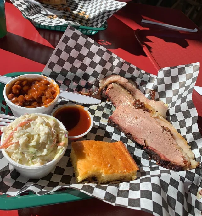 Barbecue brisket platter with sides in a casual dining setting