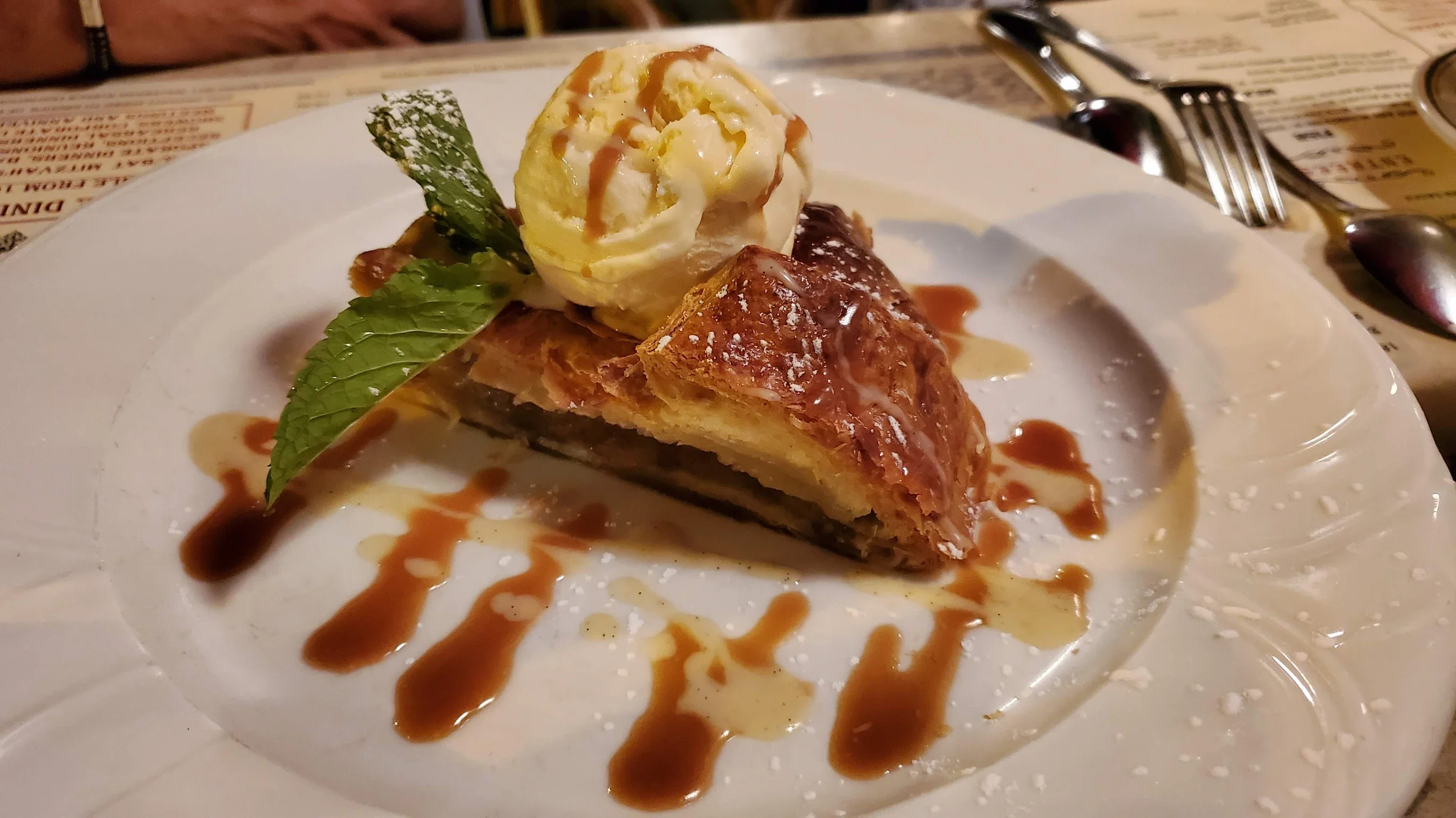 Delicious apple strudel with vanilla ice cream and caramel drizzle