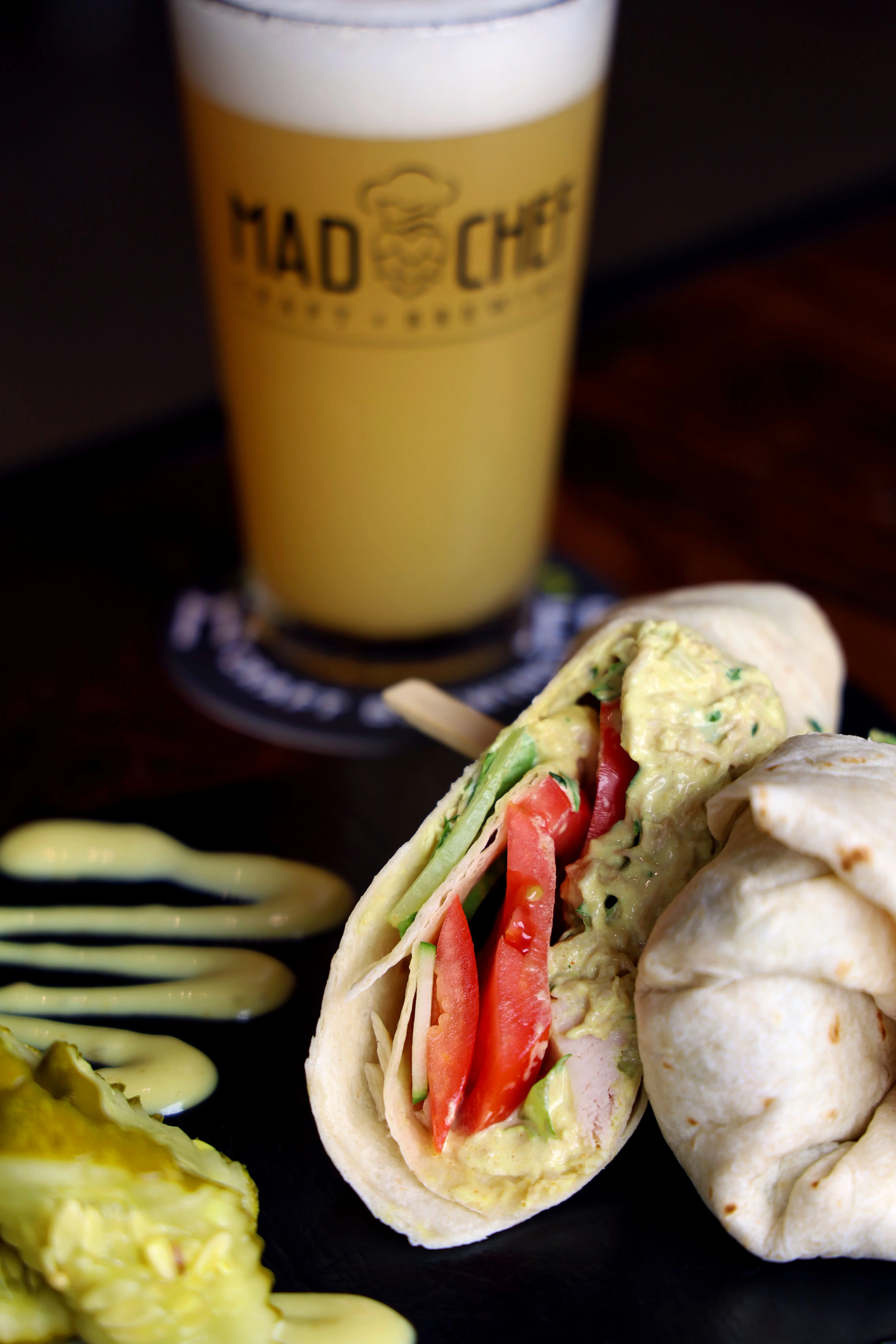 Fresh wrap with avocado and vegetables served with craft beer