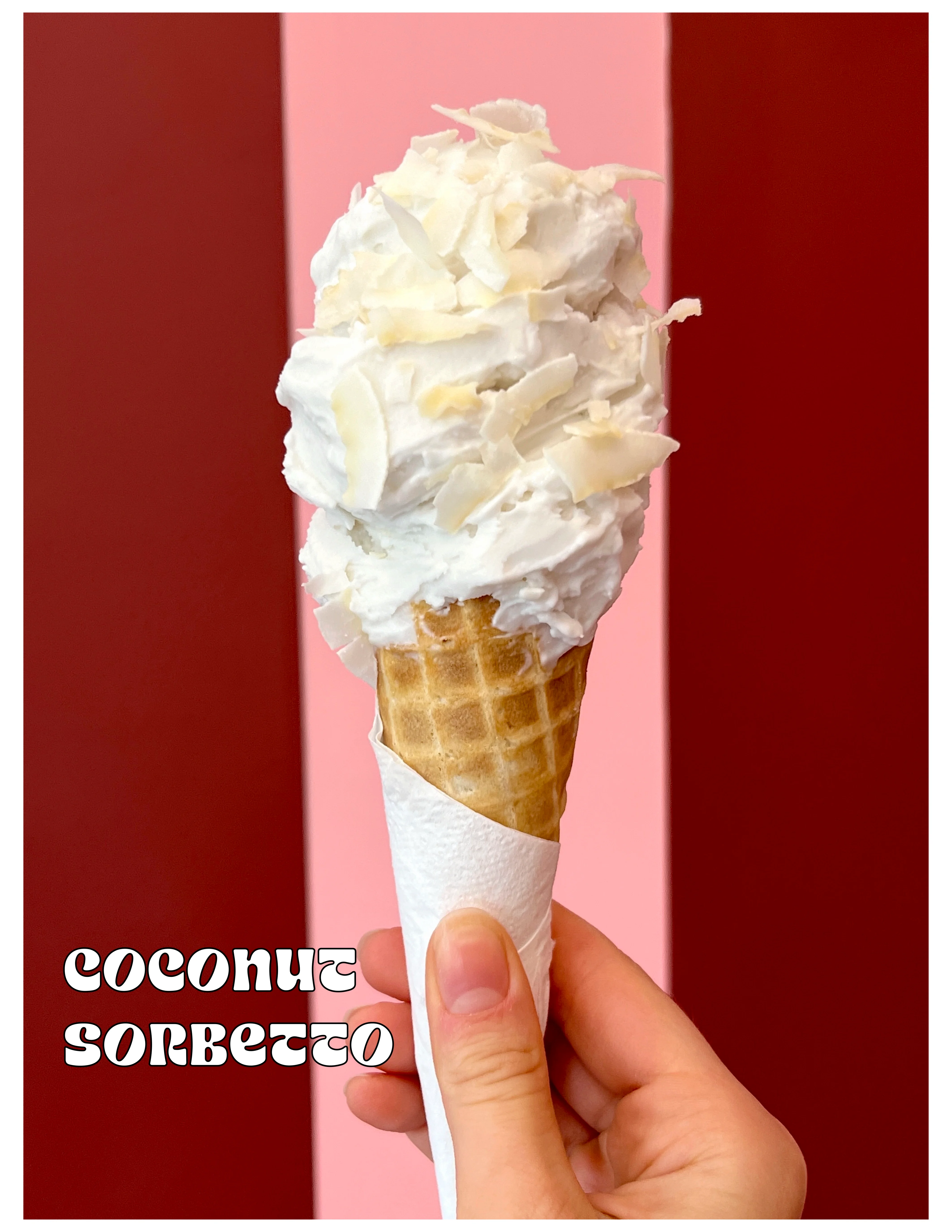 Coconut sorbet in a waffle cone with coconut flakes