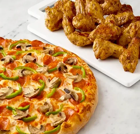 Delicious MVP pizza with fresh toppings on a wooden table