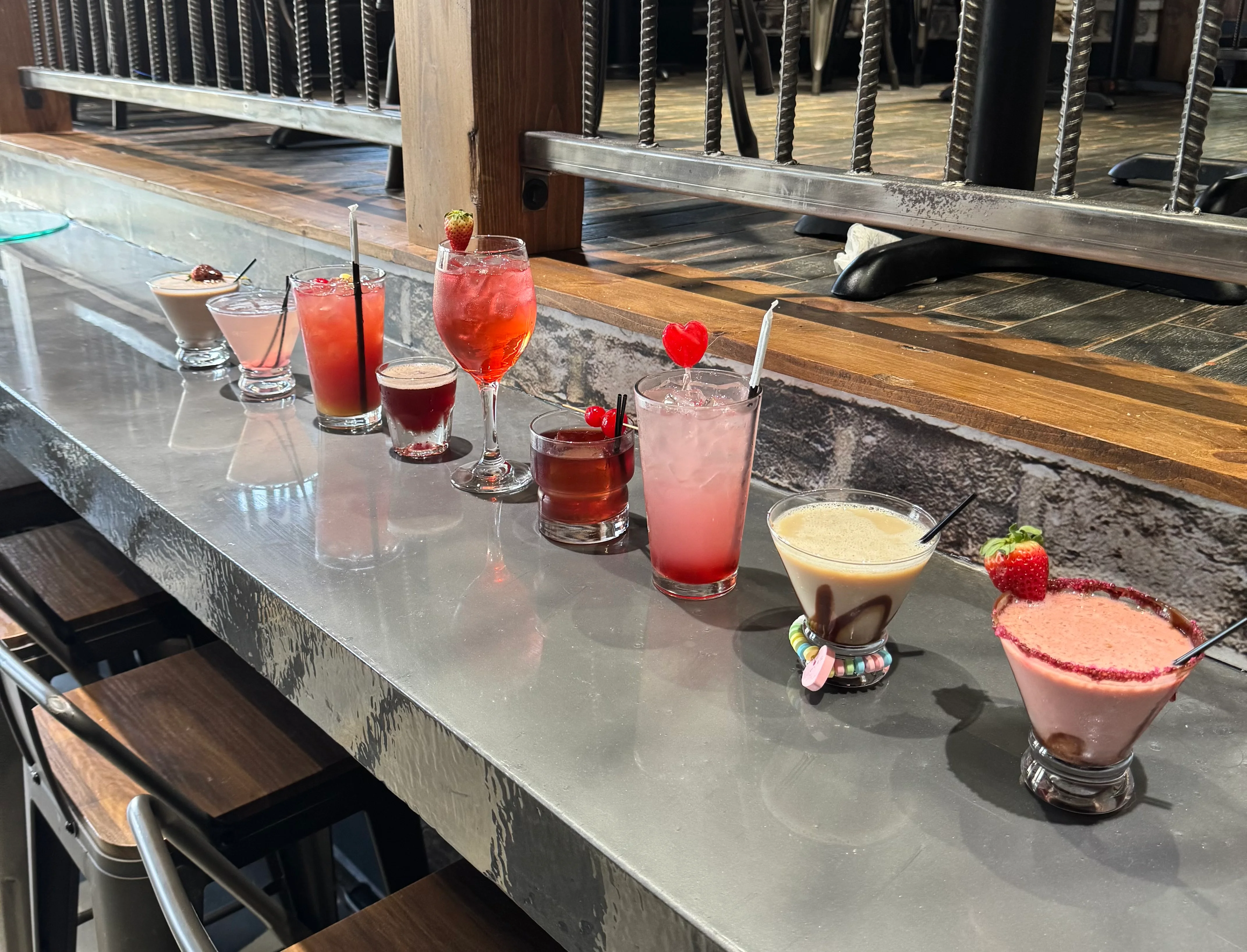 Colorful cocktails lined up on a modern bar counter