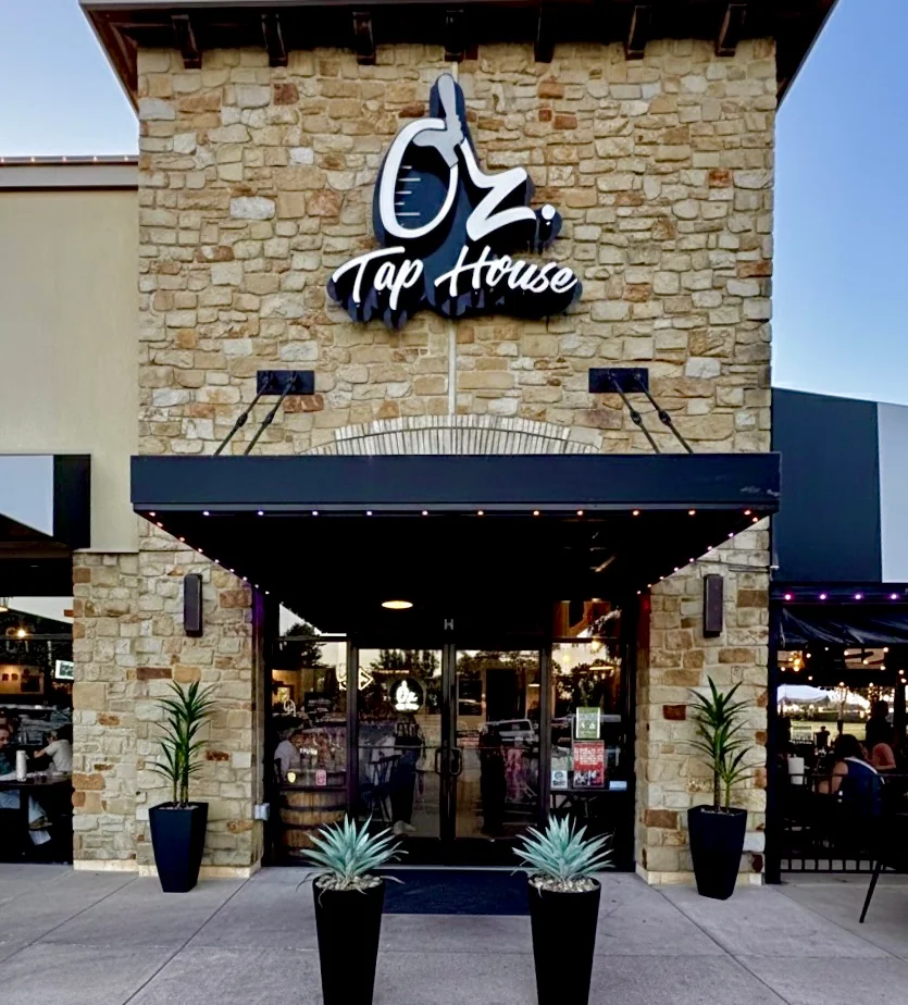 Exterior view of Oz Tap House with stone facade and modern signage