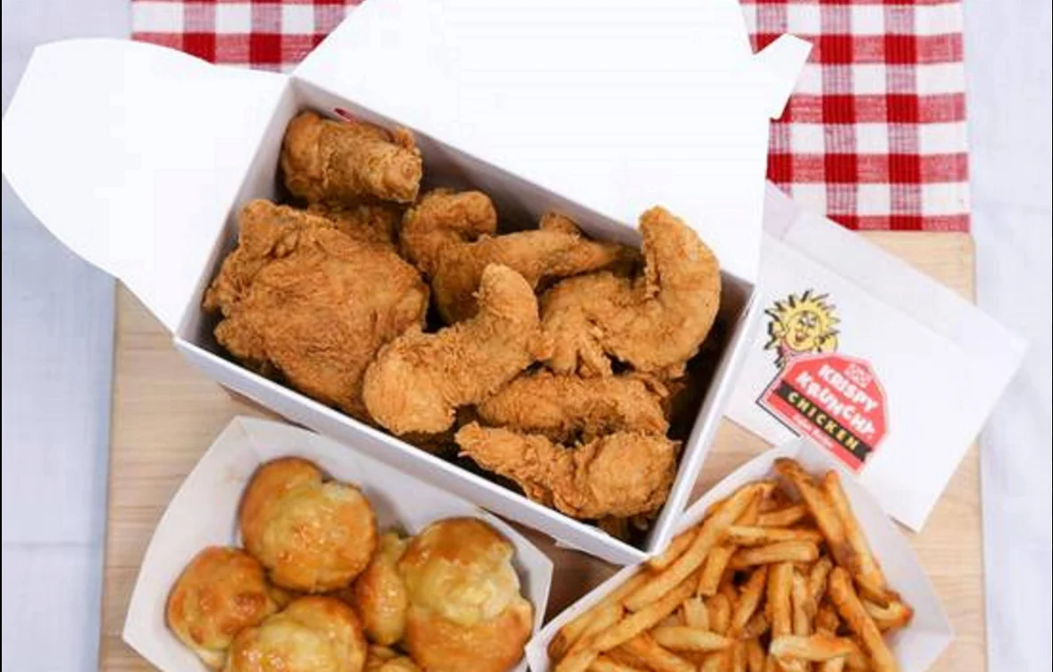 Crispy fried chicken with sides of fries and biscuits