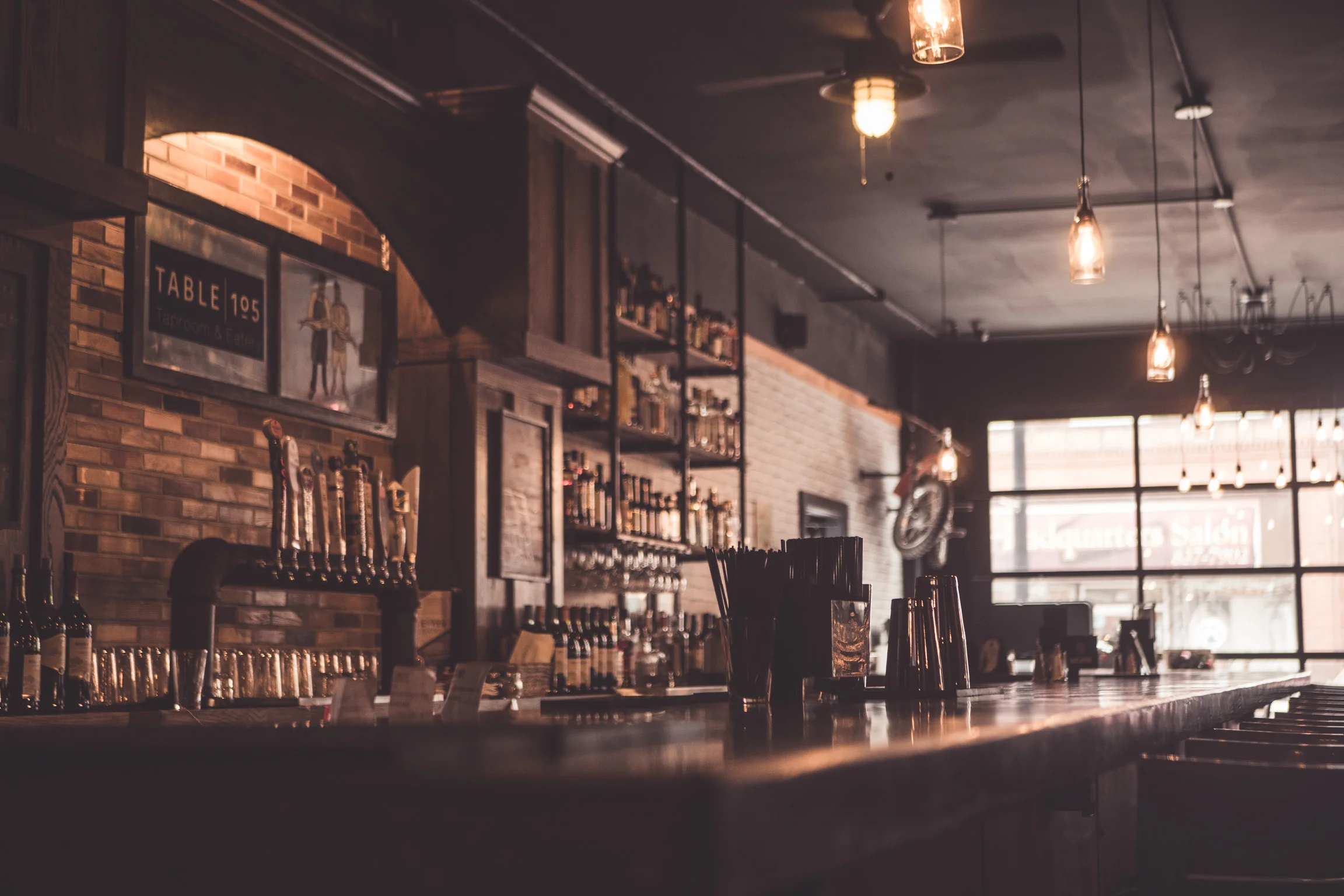 Cozy bar interior with warm lighting and wooden decor