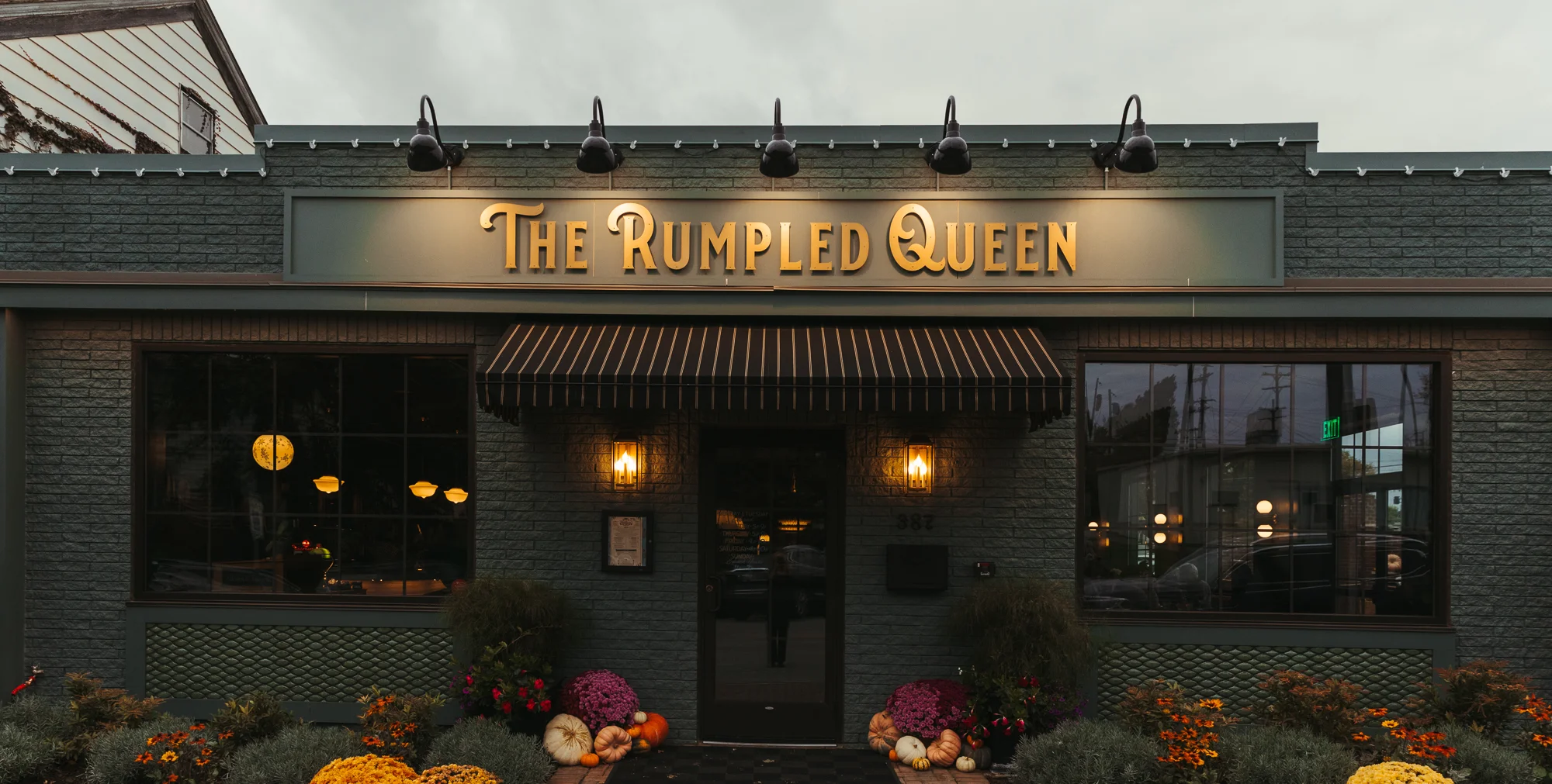 Charming restaurant exterior with seasonal flowers and warm lighting