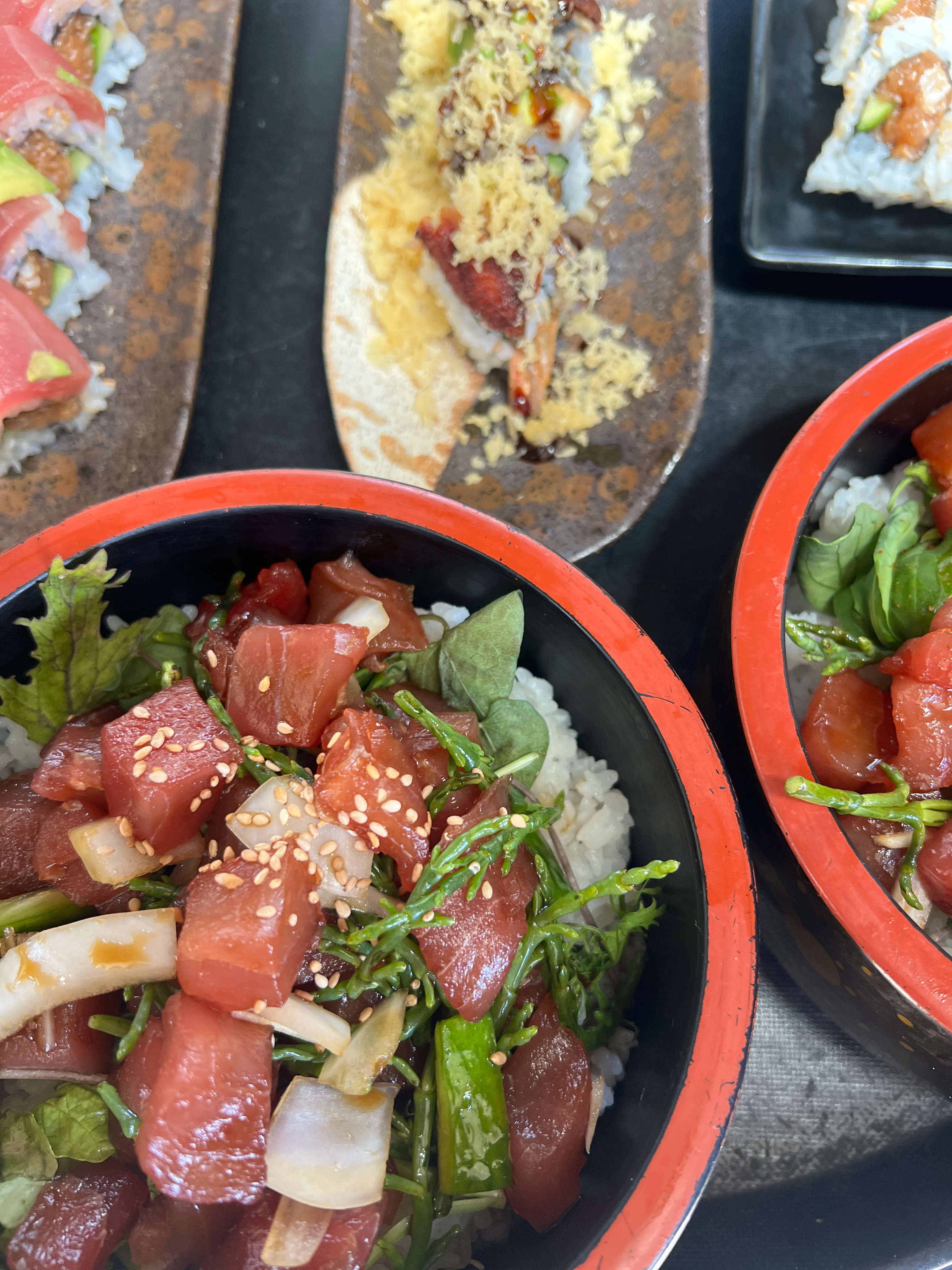 A photo of our delicious poke bowls with sesame seeds serces as a background for placing an order through our online ordering system.