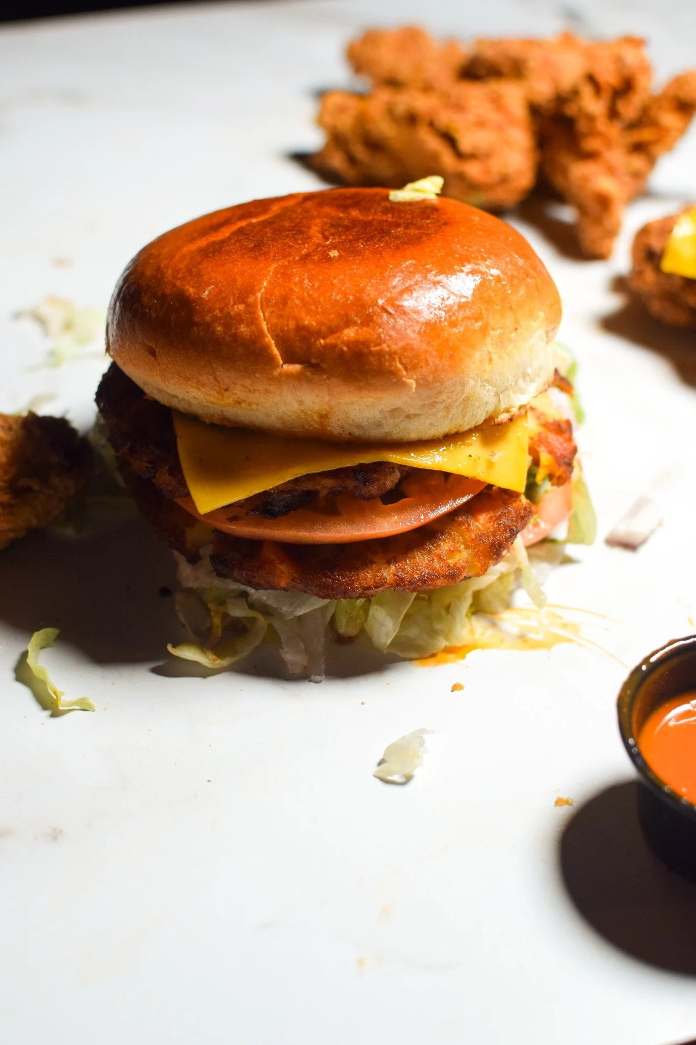 Delicious gourmet burger with fresh toppings on a wooden table.
