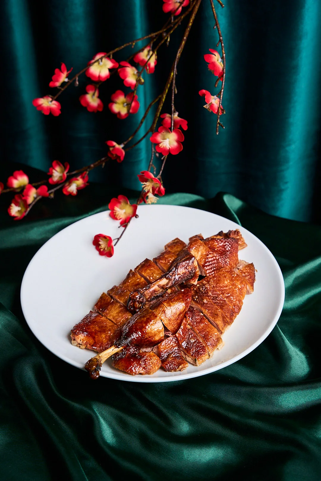 Crispy Peking duck served on a white plate