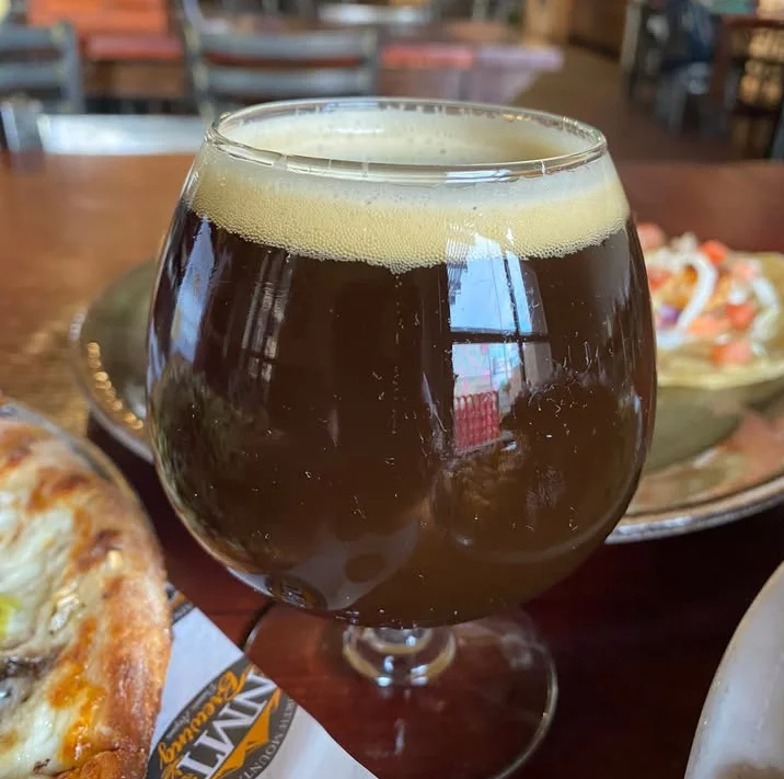 Craft beer in a tulip glass at a cozy restaurant