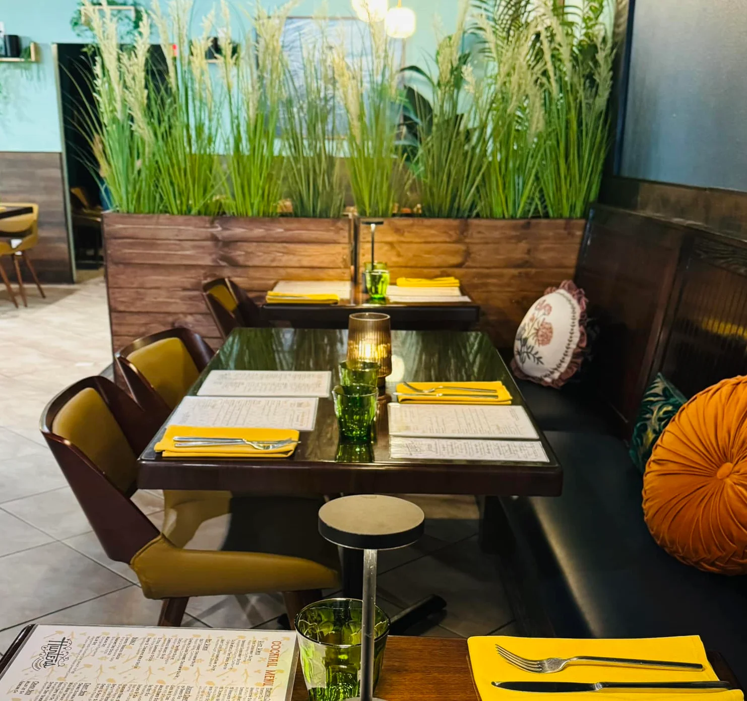 Cozy restaurant interior with green decor and warm lighting