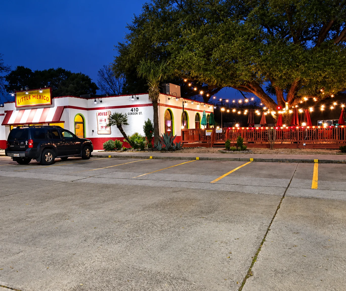 Charming exterior of Little Mexico restaurant with outdoor seating and string lights