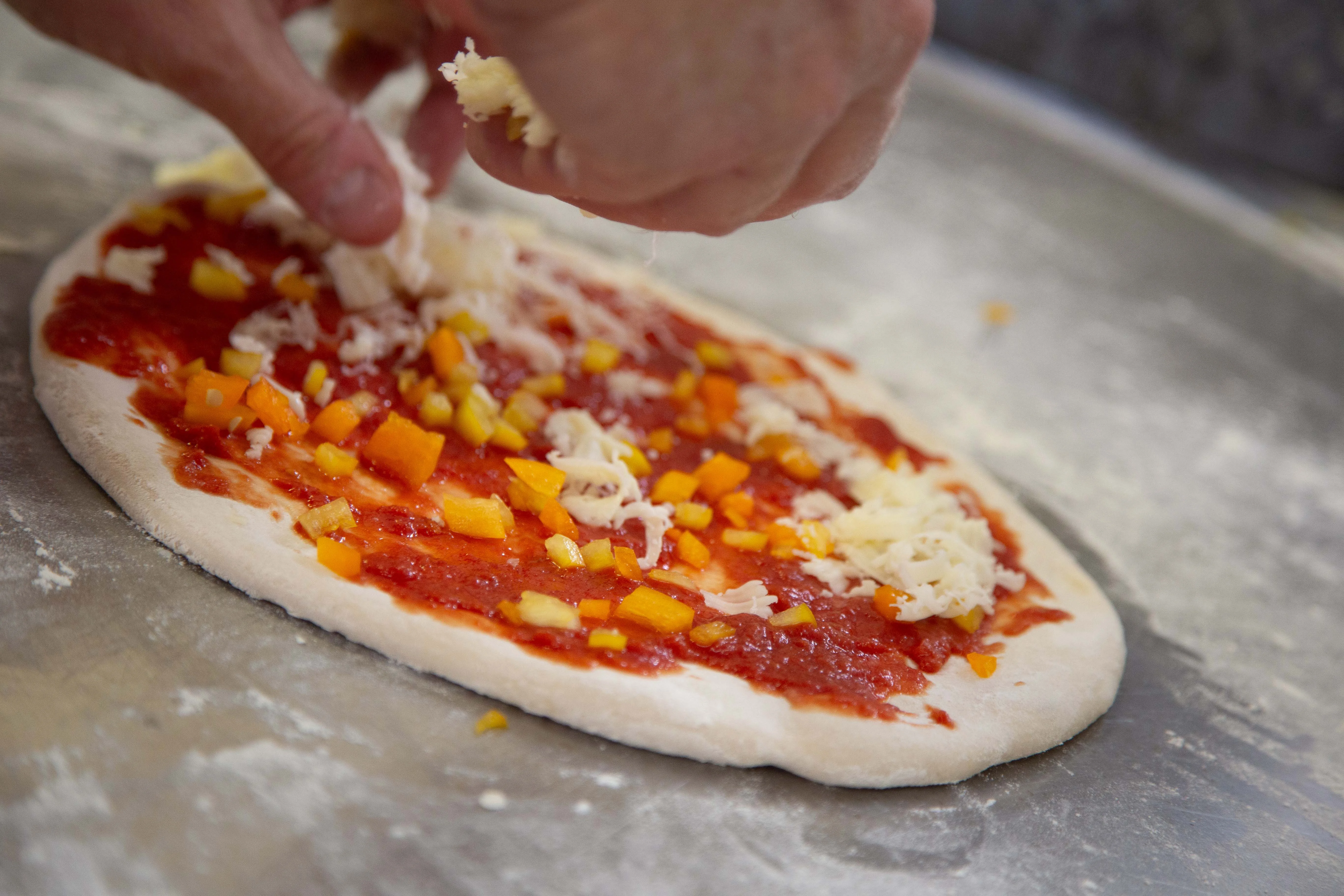 Crafting a Margherita pizza with fresh toppings