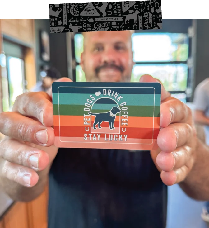 Customer holding a loyalty card at a pet-friendly coffee shop