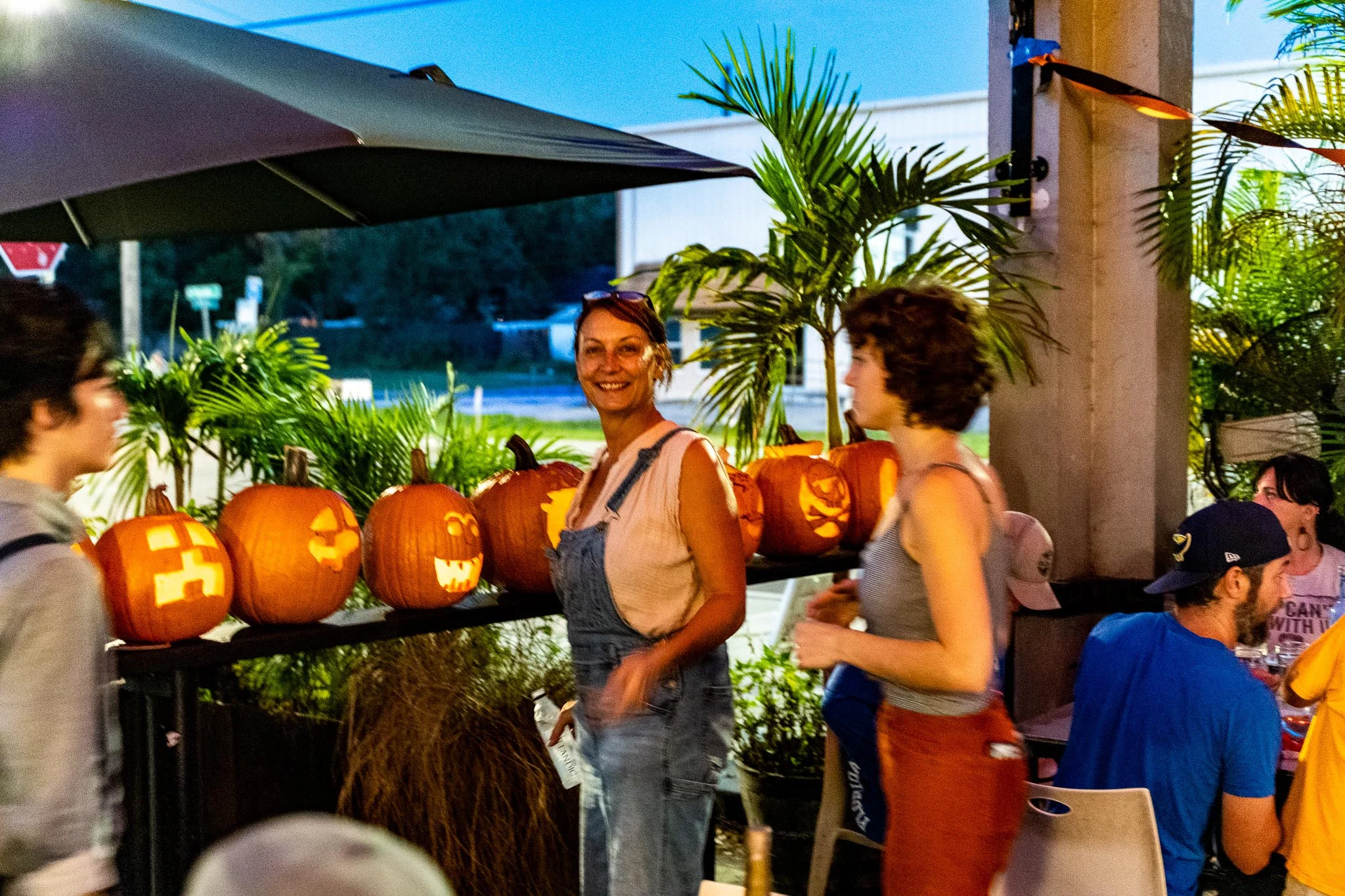 Outdoor Halloween event with carved pumpkins and smiling guests