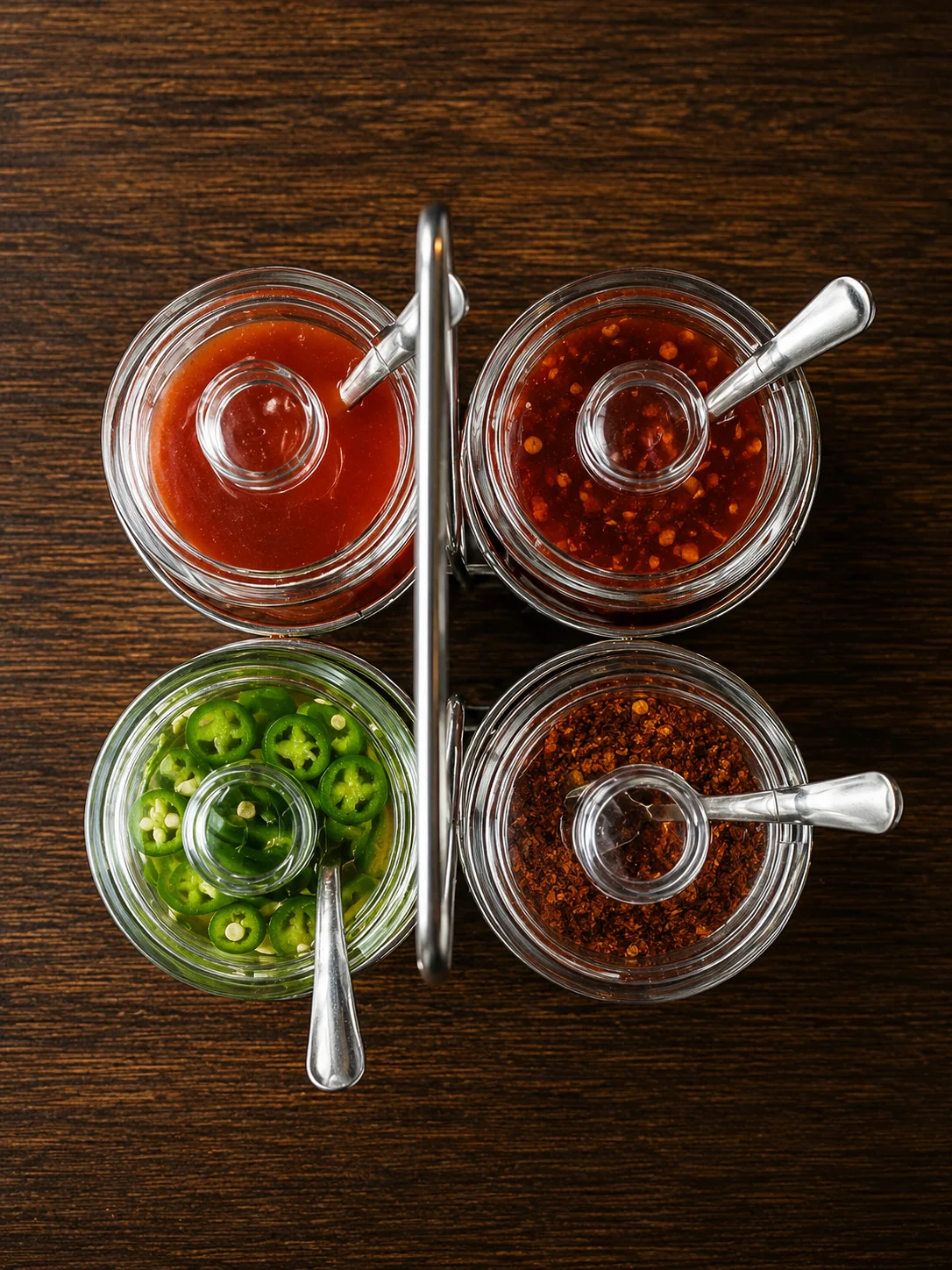 Variety of spicy sauces and condiments in glass jars