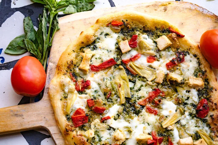 Pesto chicken pizza with artichokes and sun-dried tomatoes