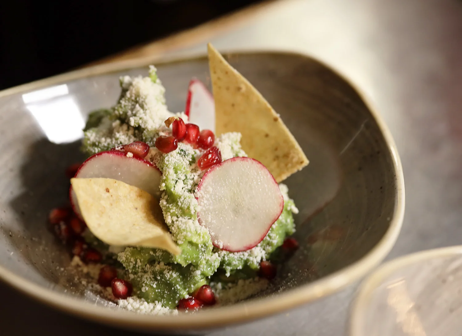 Mexican guacamole salad with radishes and pomegranate