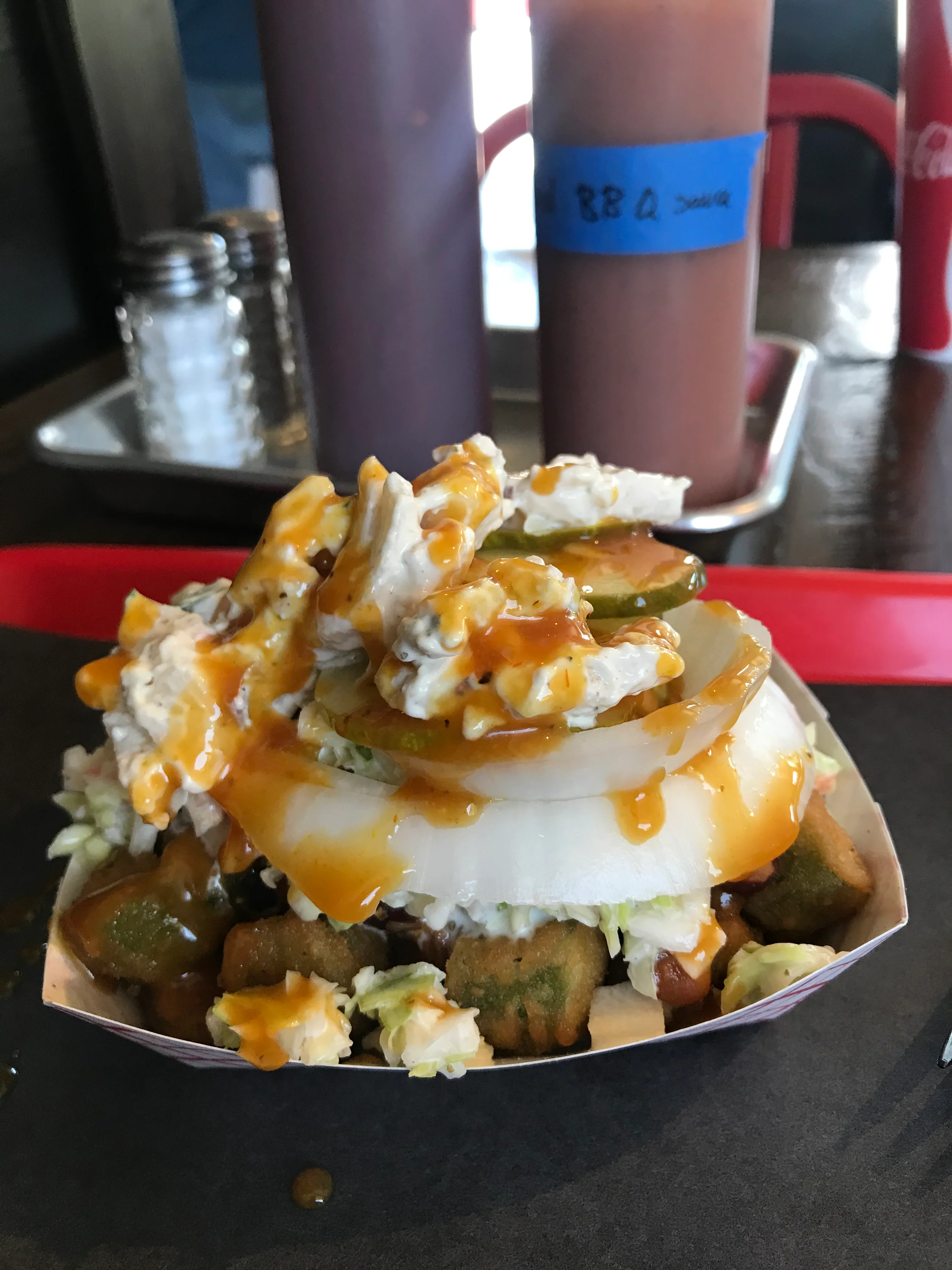 Delicious burger with toppings served on a wooden table