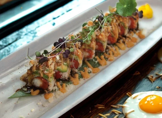 Japanese sushi roll with fresh seafood and garnishes