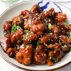 Sweet and sour chicken with sesame garnish