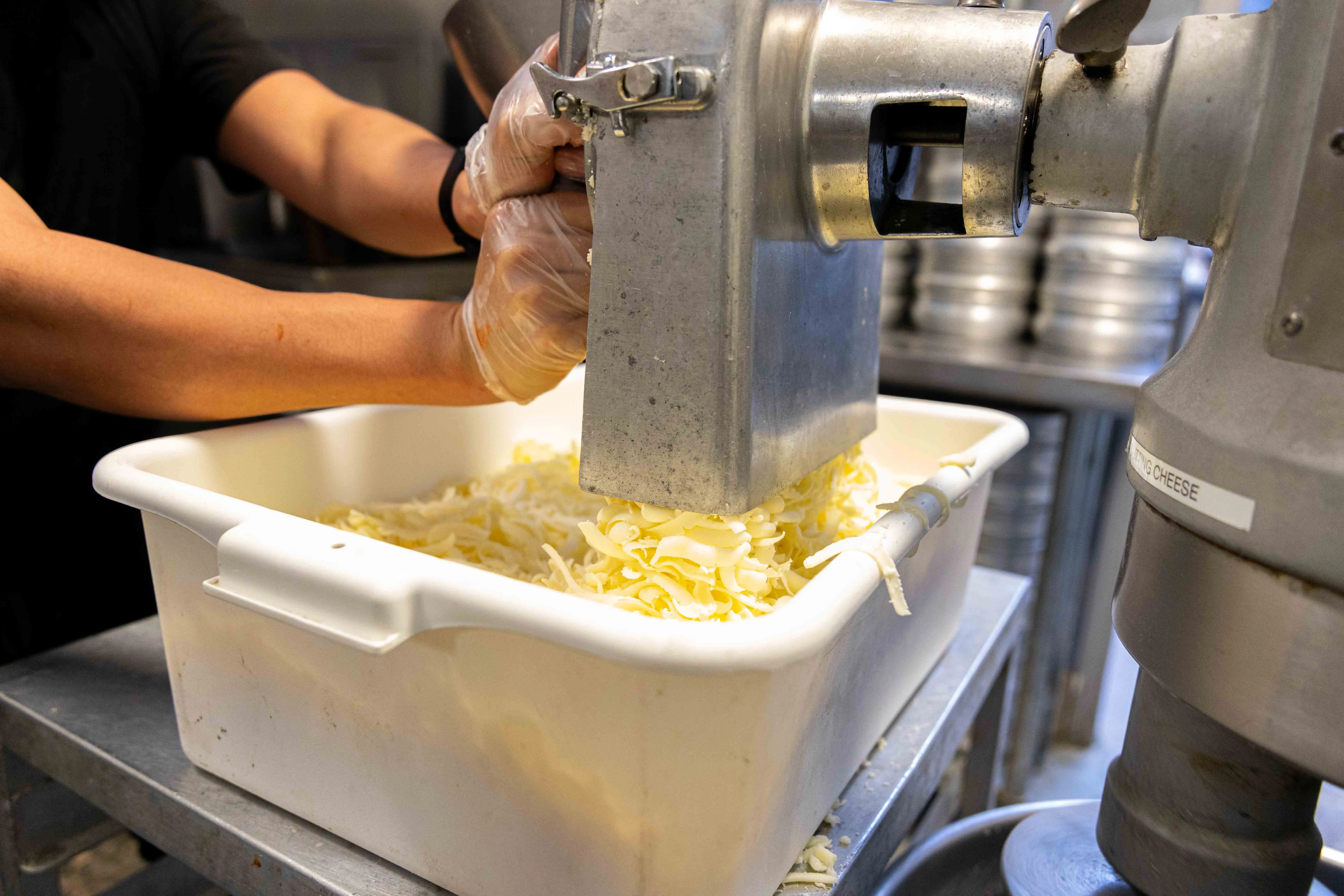 Shredding cheese in a commercial kitchen