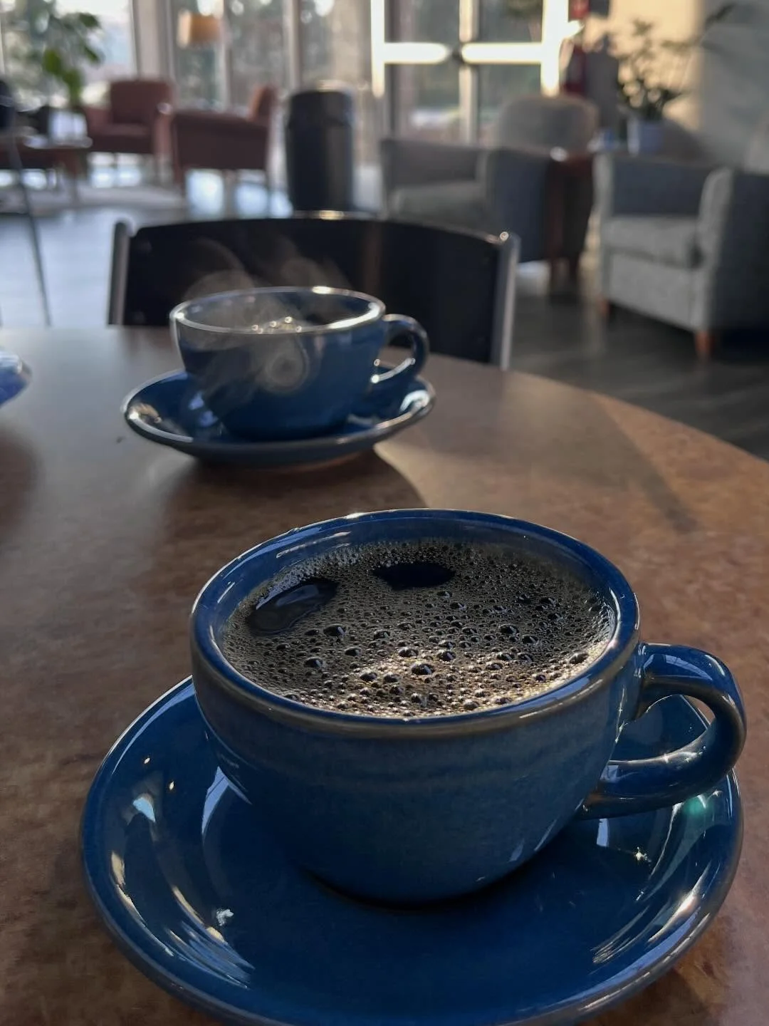 Coffee cup from More Than Coffee café with tea menu in background