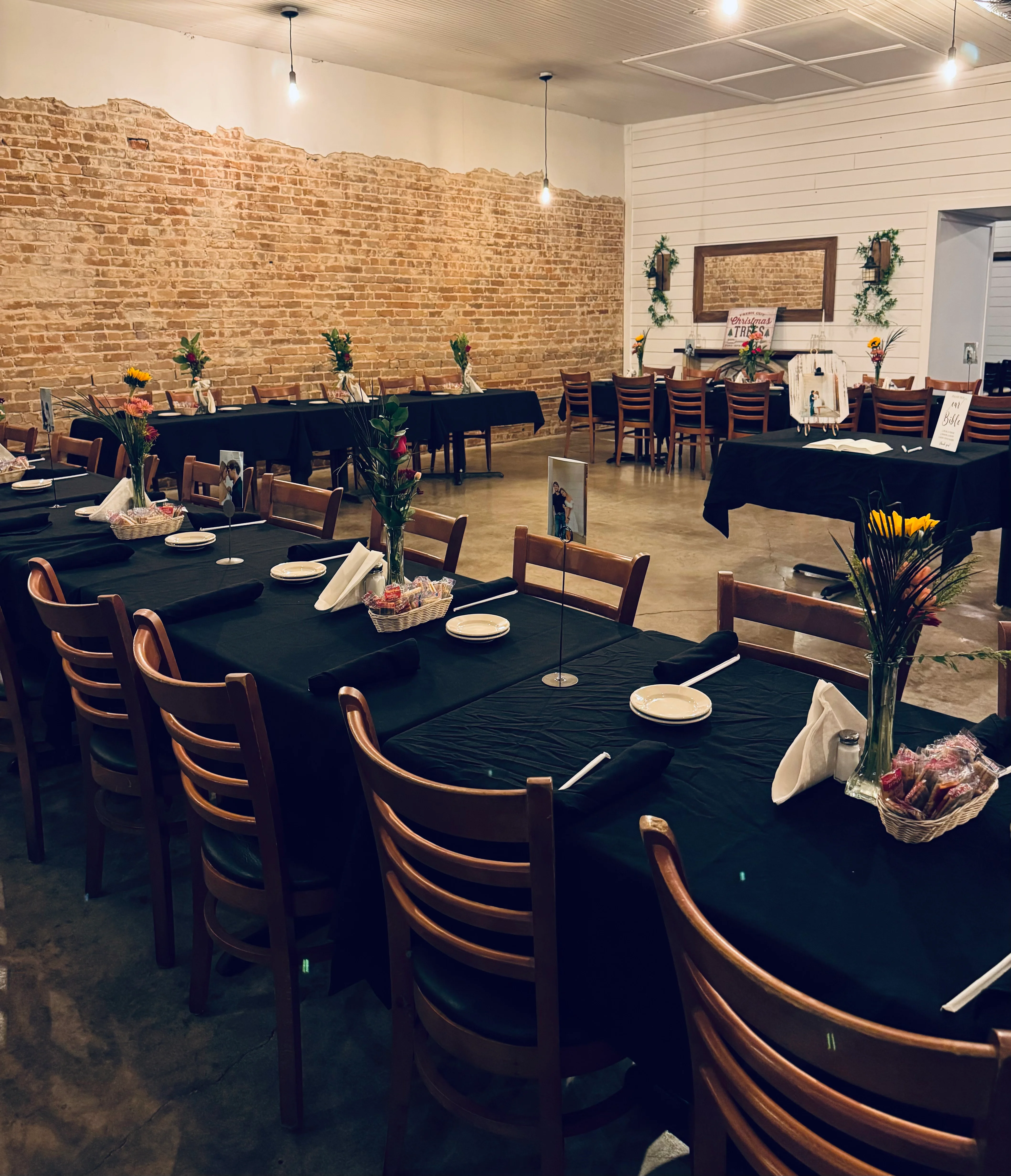 Cozy restaurant interior featuring wooden tables and exposed brick walls.
