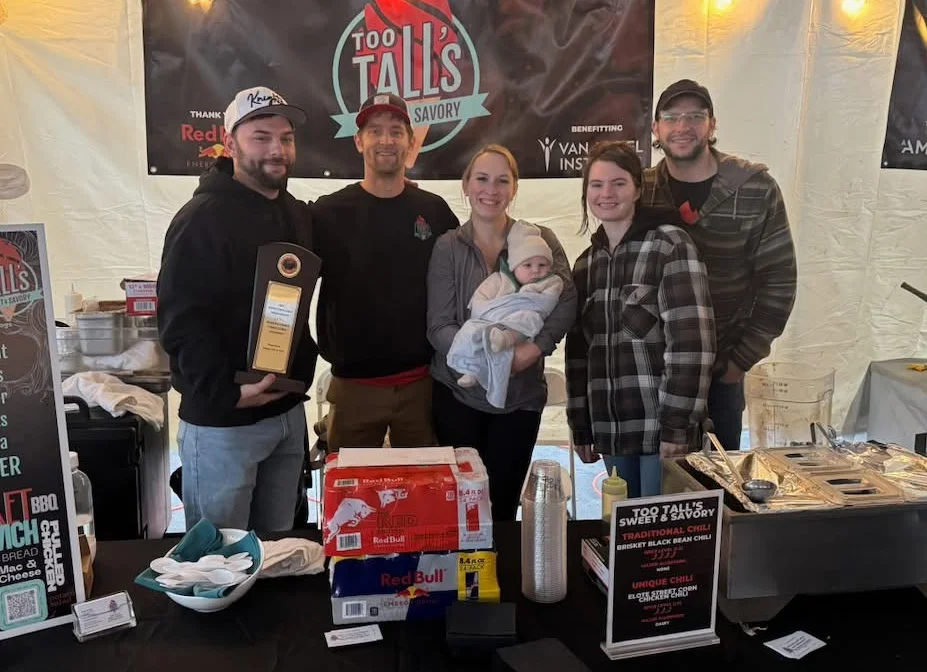 Team at Too Tall's Sweet & Savory food stall with award and baby