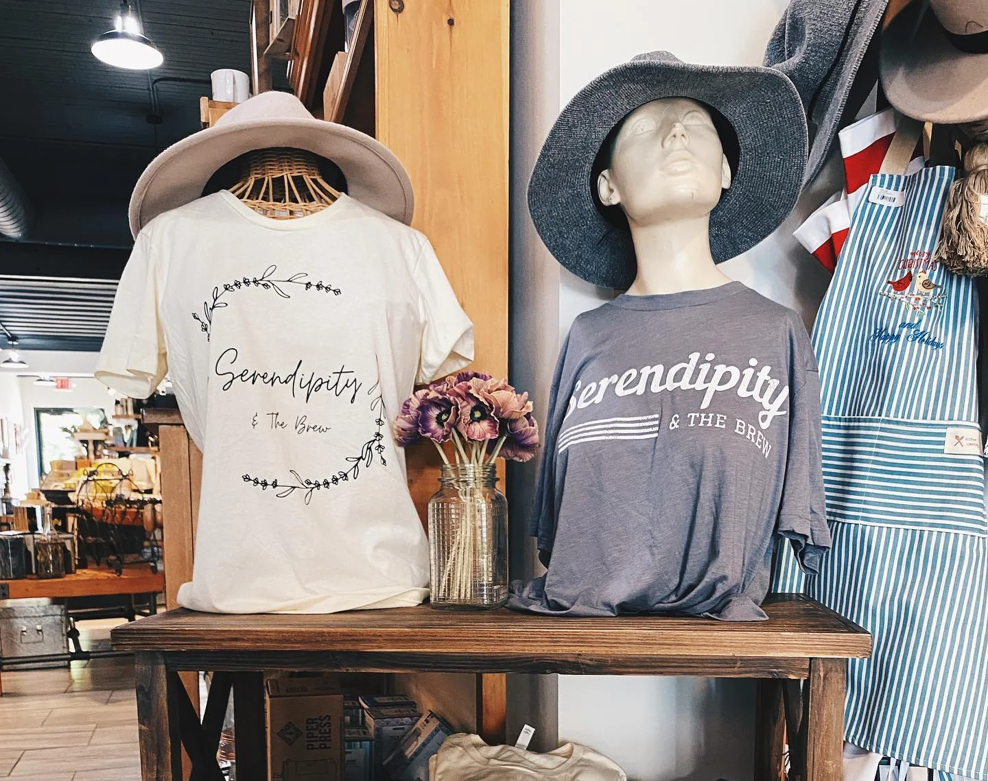 Display of Serendipity t-shirts in a cozy shop setting