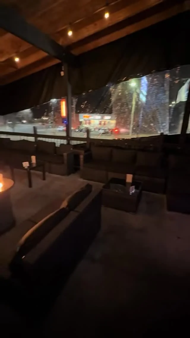 Cozy outdoor lounge area with seating and warm lighting