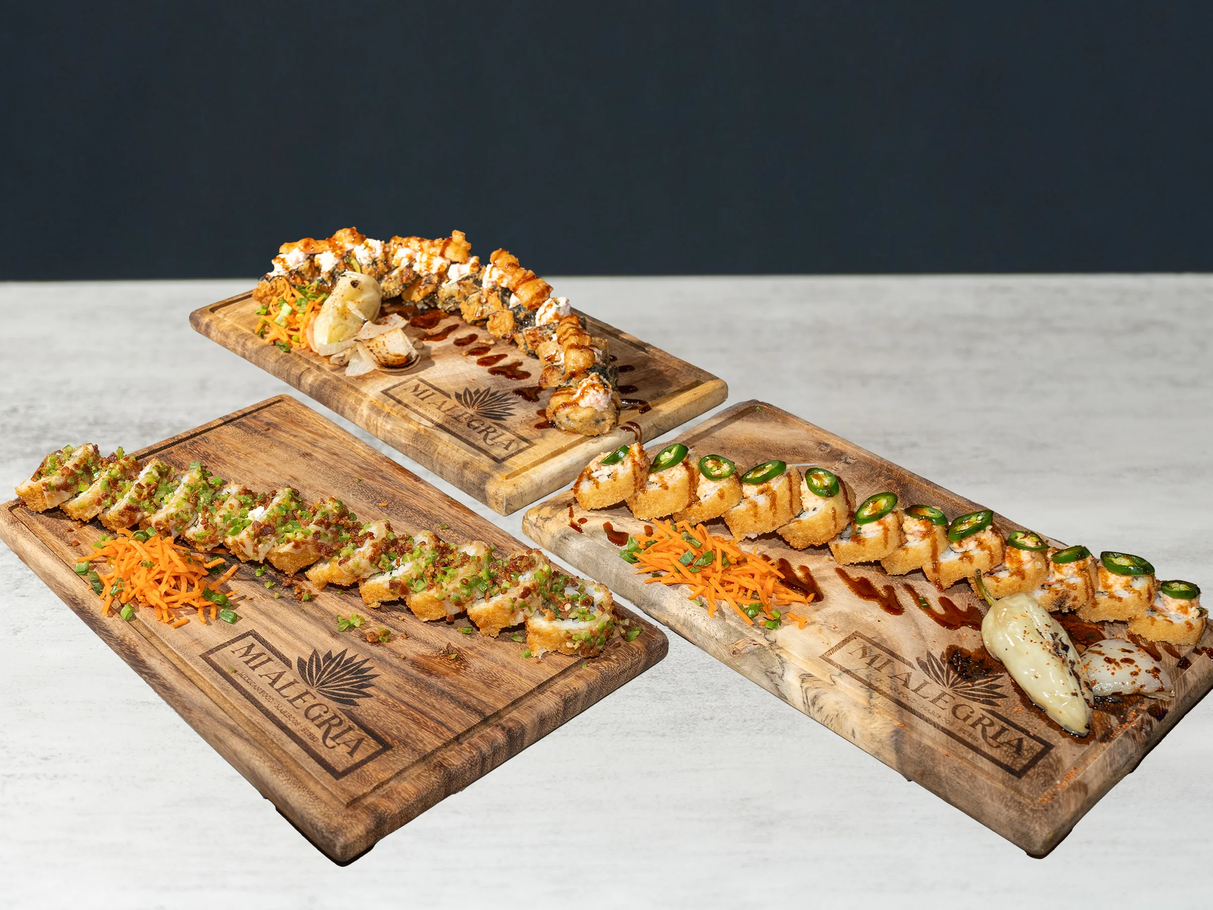 Assorted sushi rolls on wooden platters