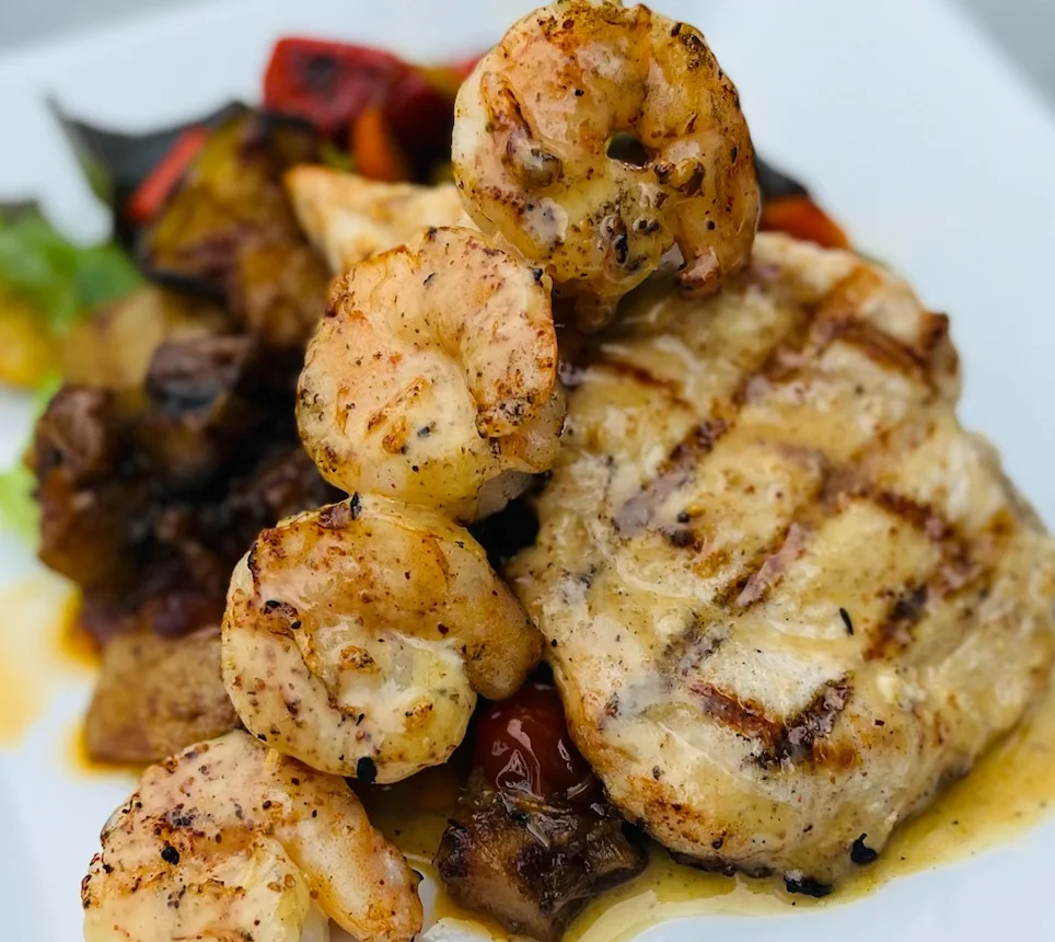 Grilled shrimp and fish platter with seasonal vegetables