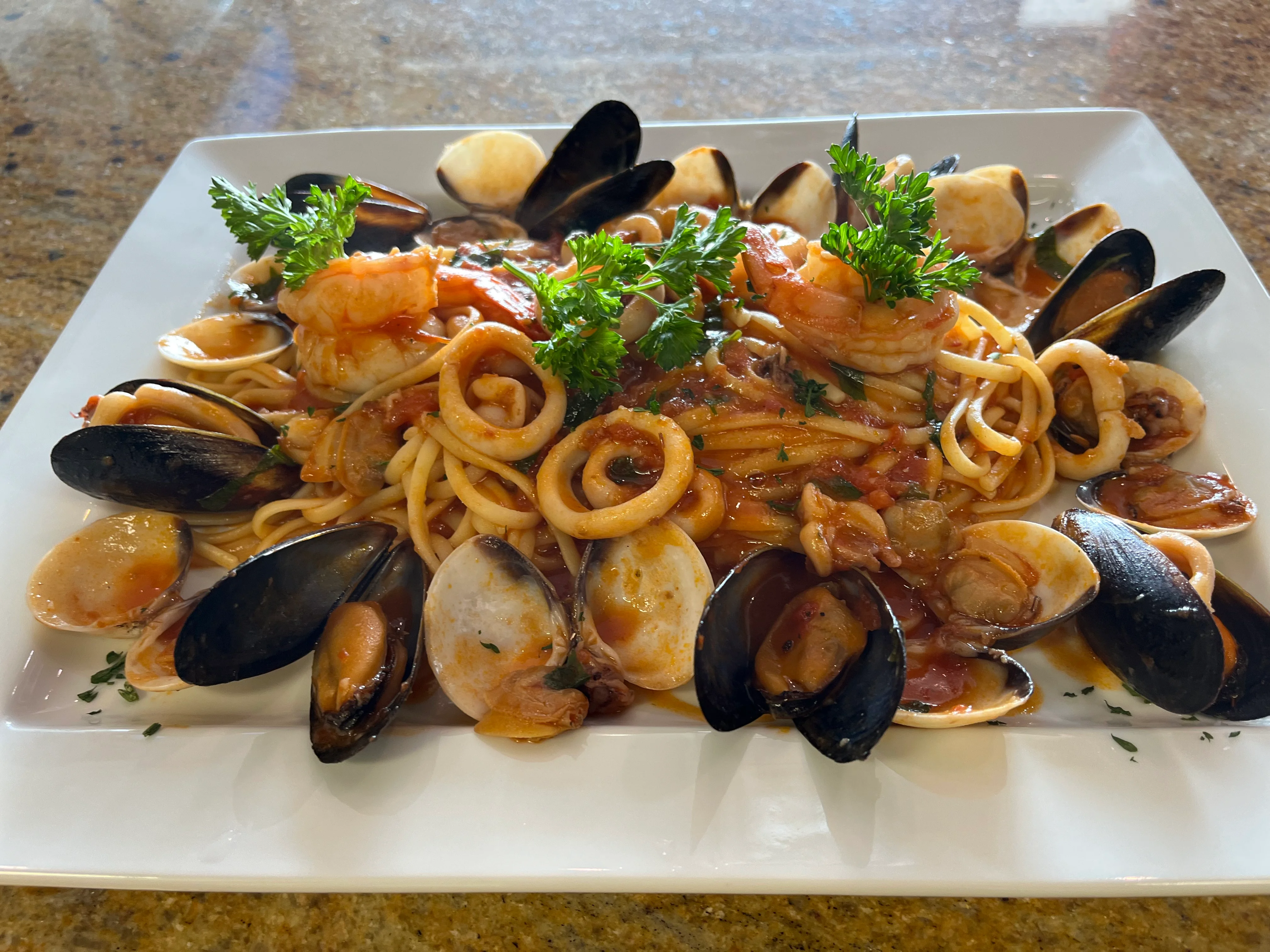 Seafood spaghetti marinara with fresh herbs