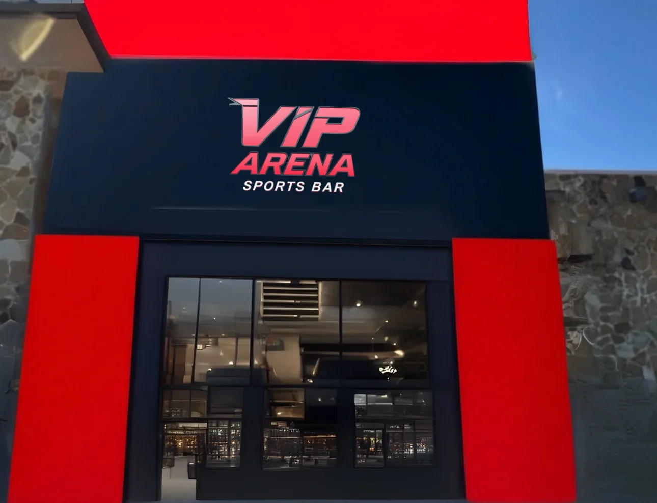 Exterior view of VIP Arena Sports Bar with modern design and bright signage.